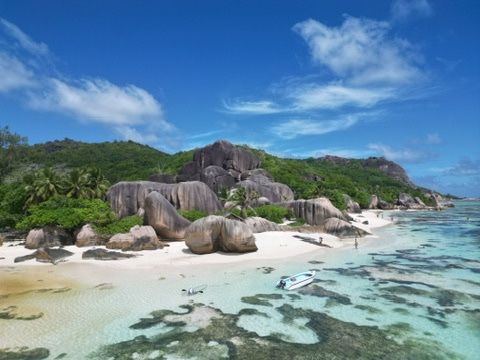 Tropical beach paradise with turquoise waters and dramatic granite rock formations at La Digue, Seychelles.