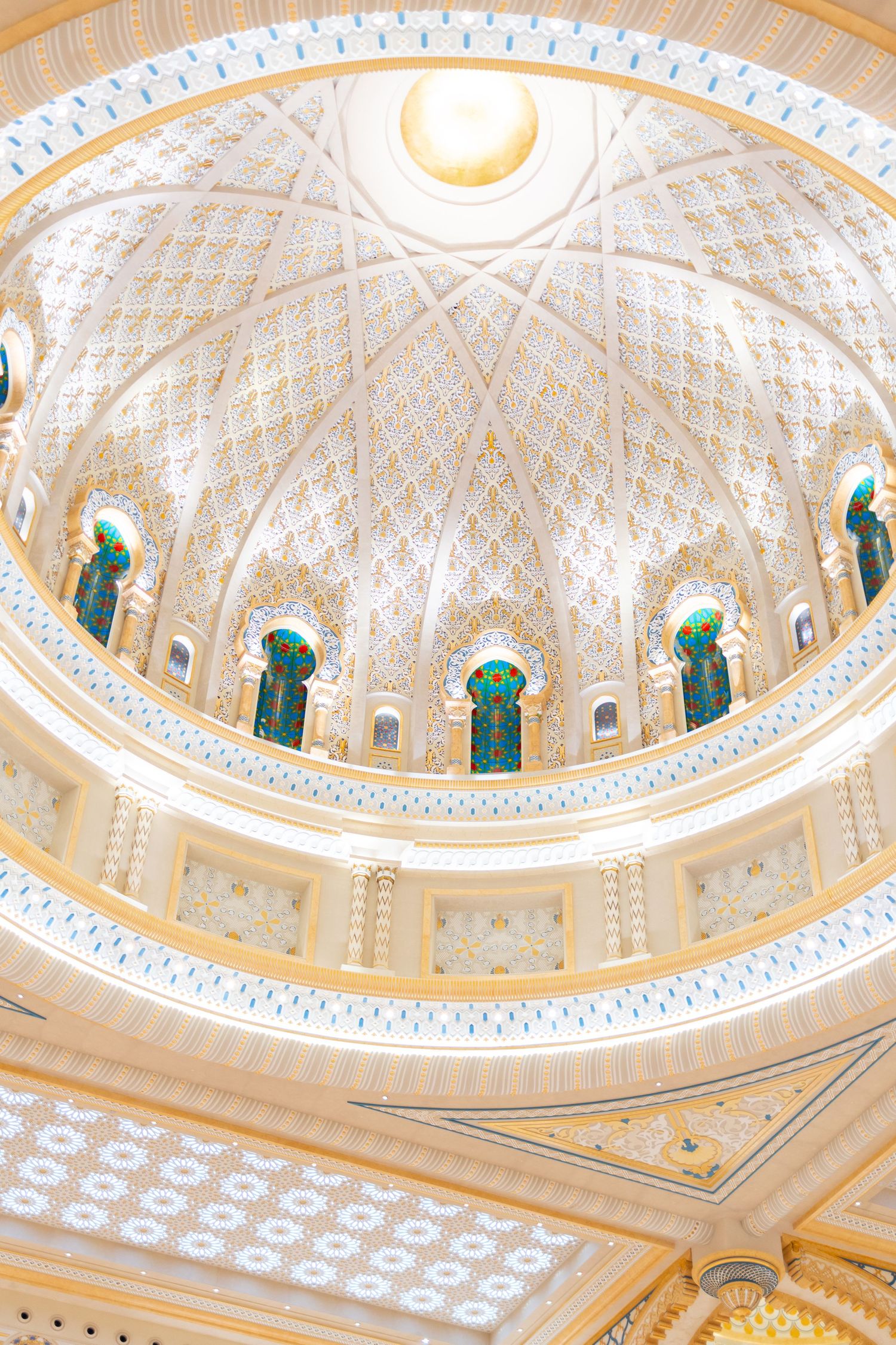 Ornate domed ceiling with intricate Islamic architectural details and circular skylight.