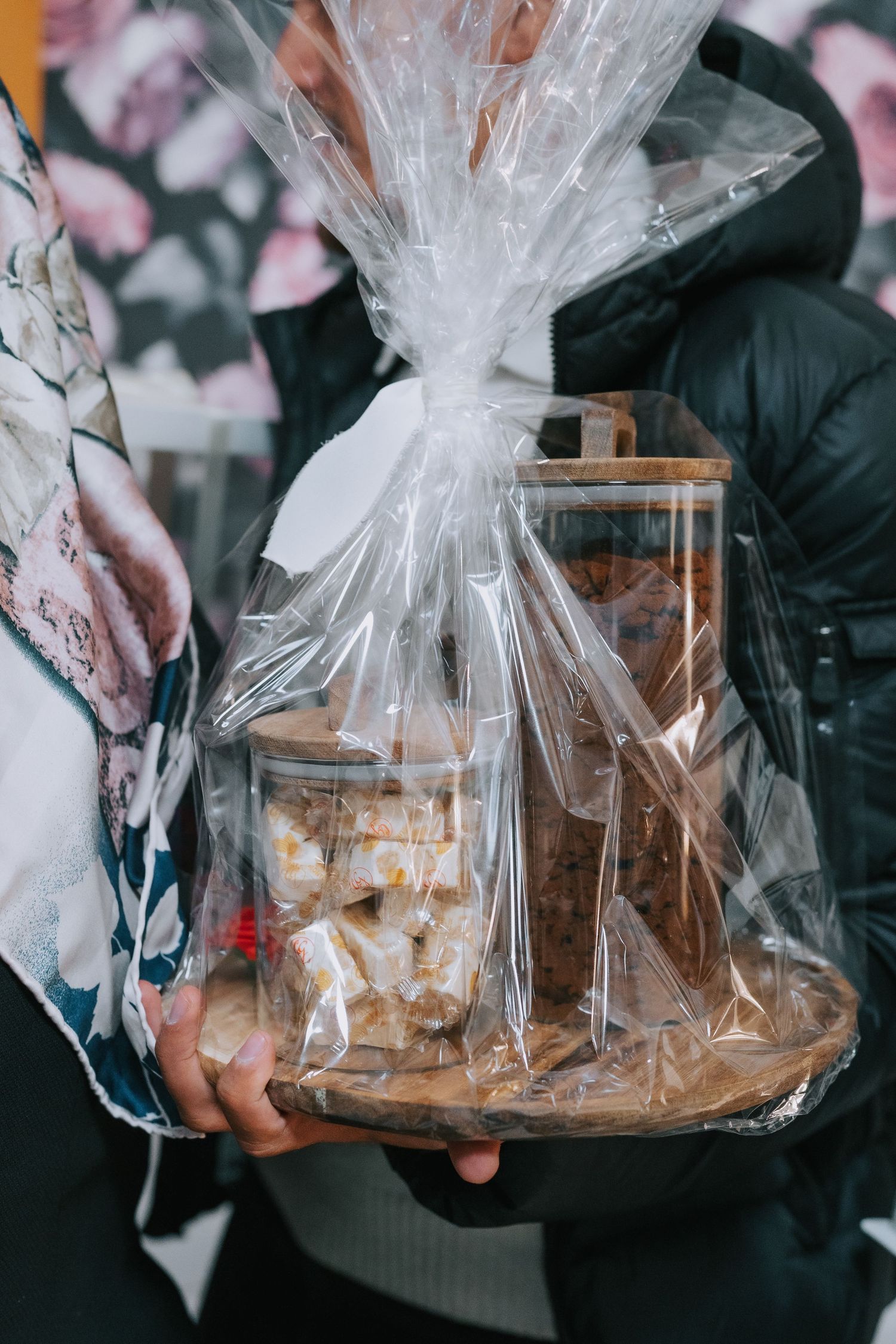 Clear plastic wrapped gift baskets containing treats and decorative items.