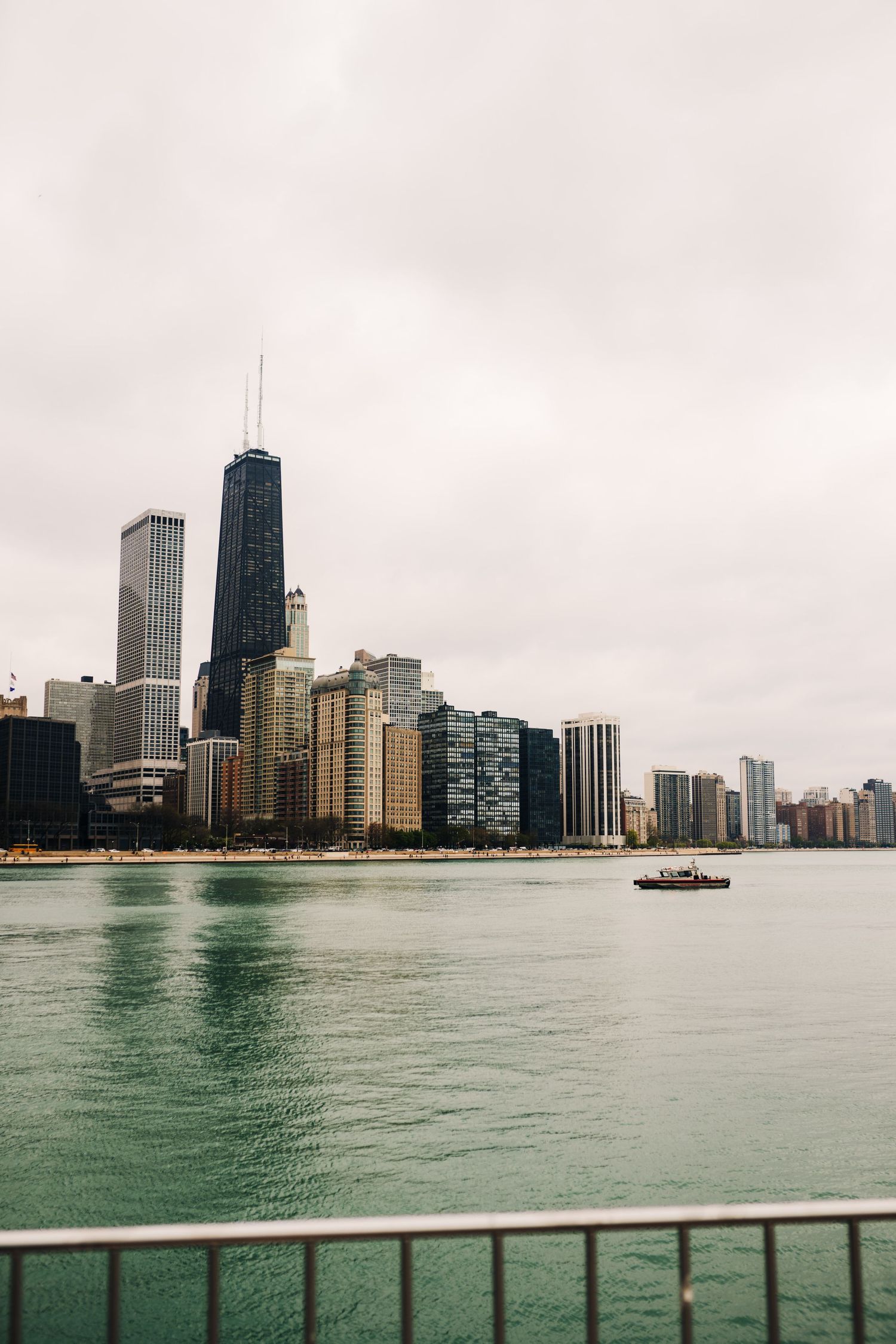 Chicago skyline with John Hancock building viewed across Lake Michigan on an overcast day.