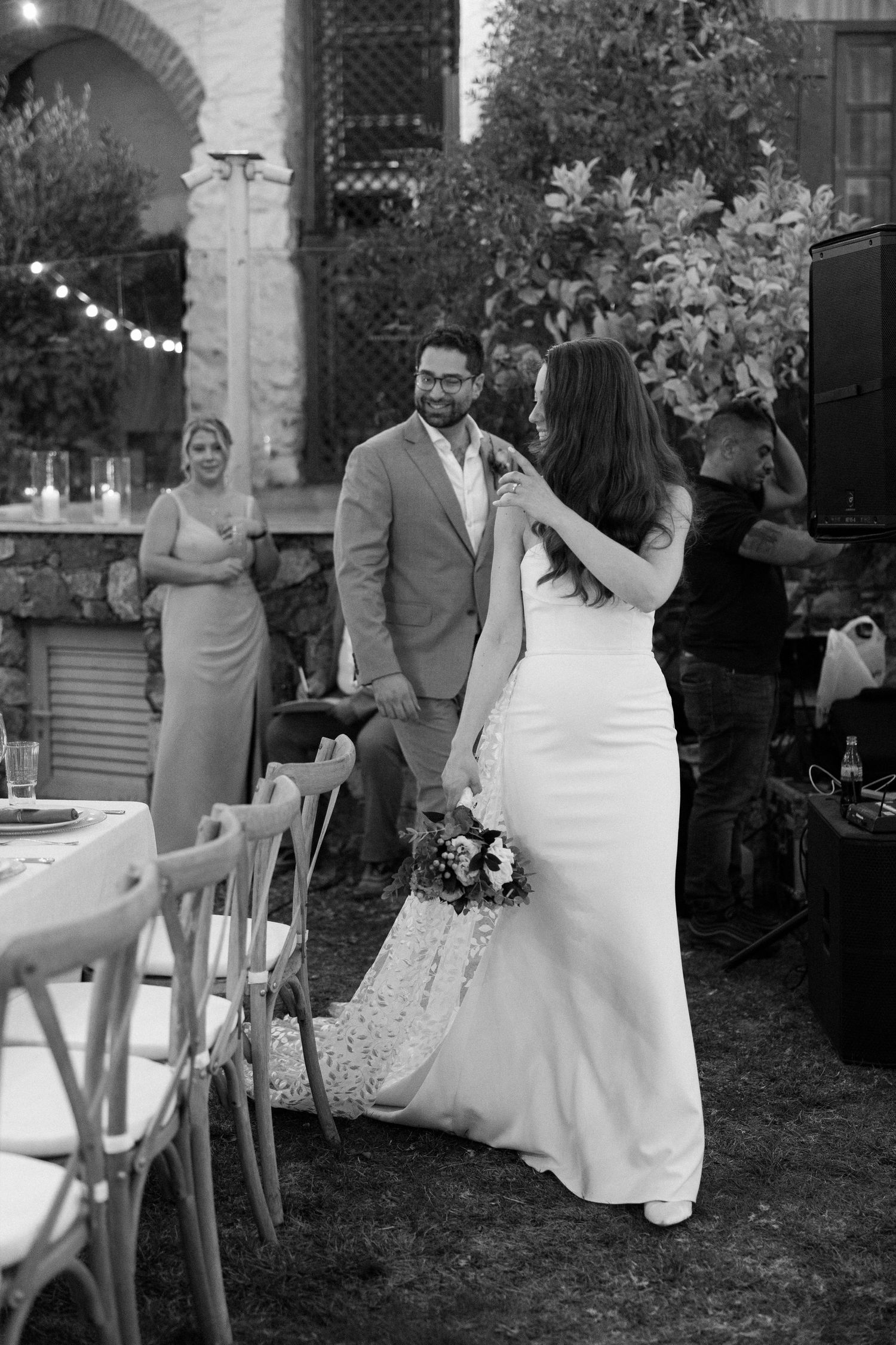 Outdoor wedding celebration with elegant decor and string lights.