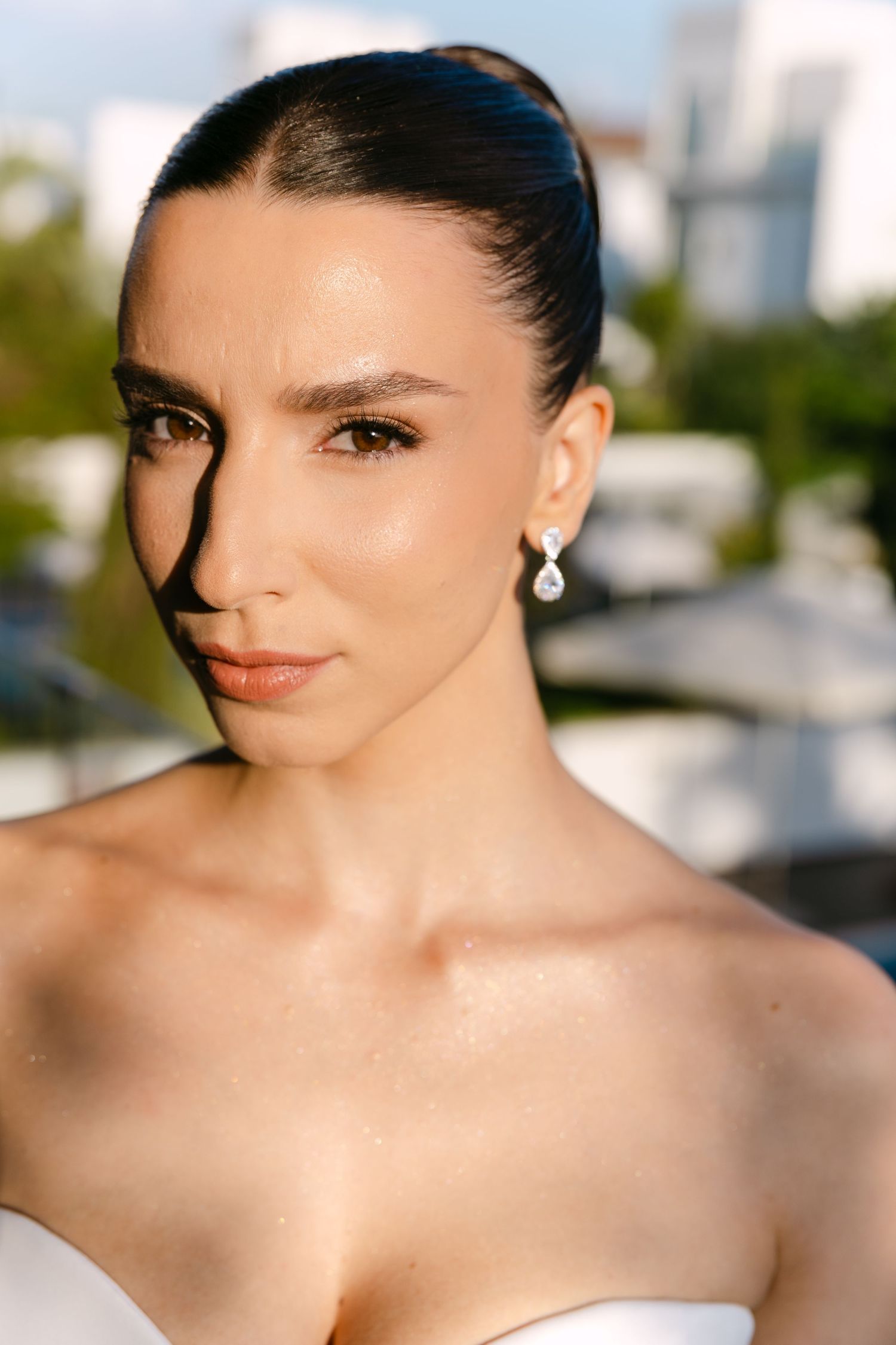 Elegant bridal portrait showing strapless dress and sophisticated makeup details.