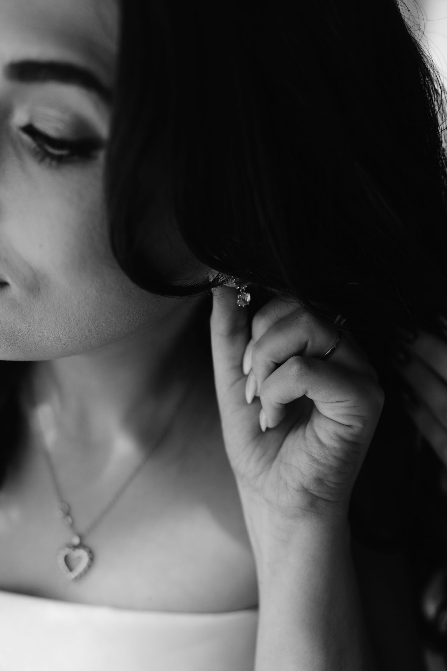 Artistic black and white close-up showing jewelry and delicate details.