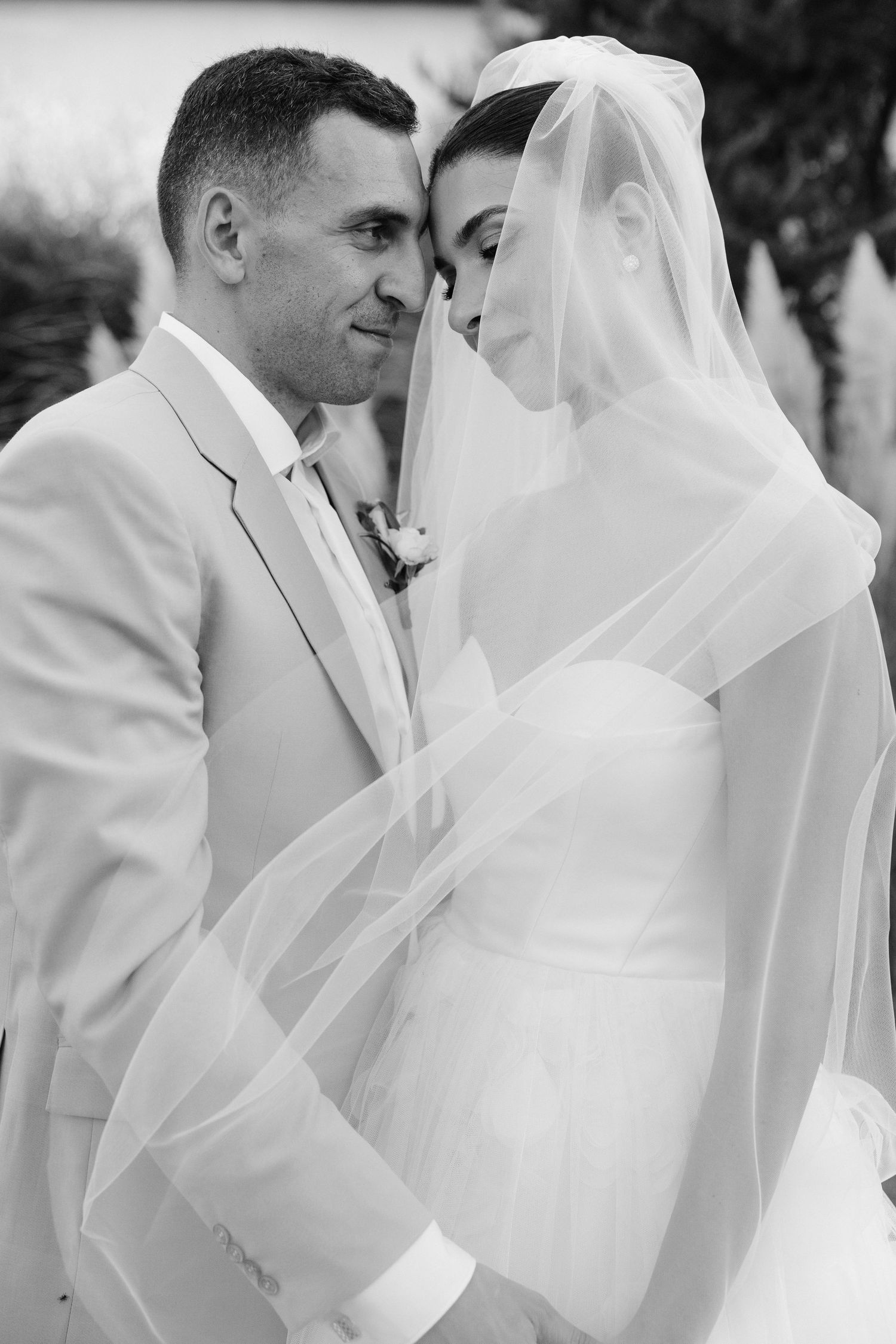 Black and white wedding photography sequence showing intimate moments in elegant attire.