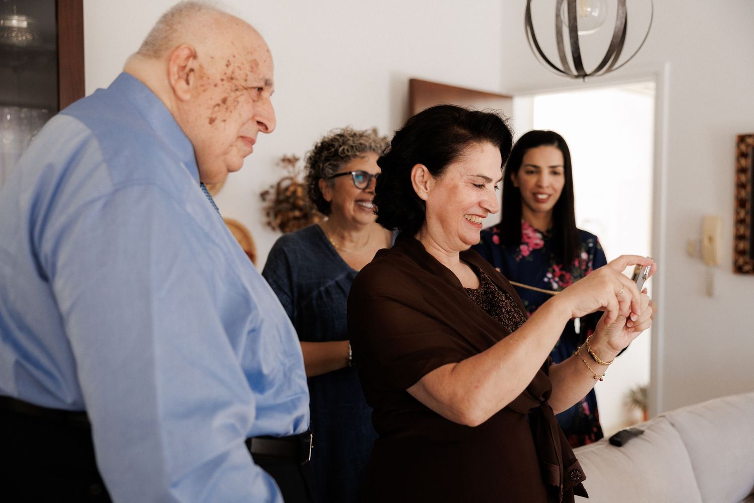 Group of people sharing an emotional moment in a bright interior setting.