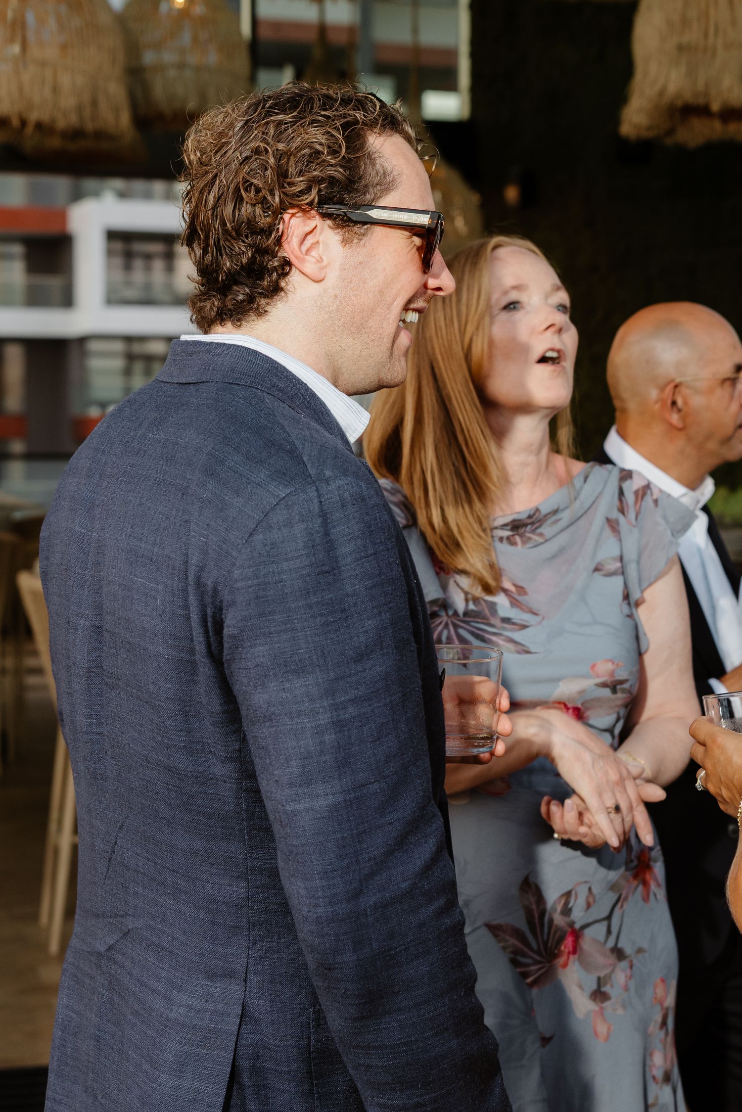 Group enjoying conversation and drinks at upscale evening gathering.