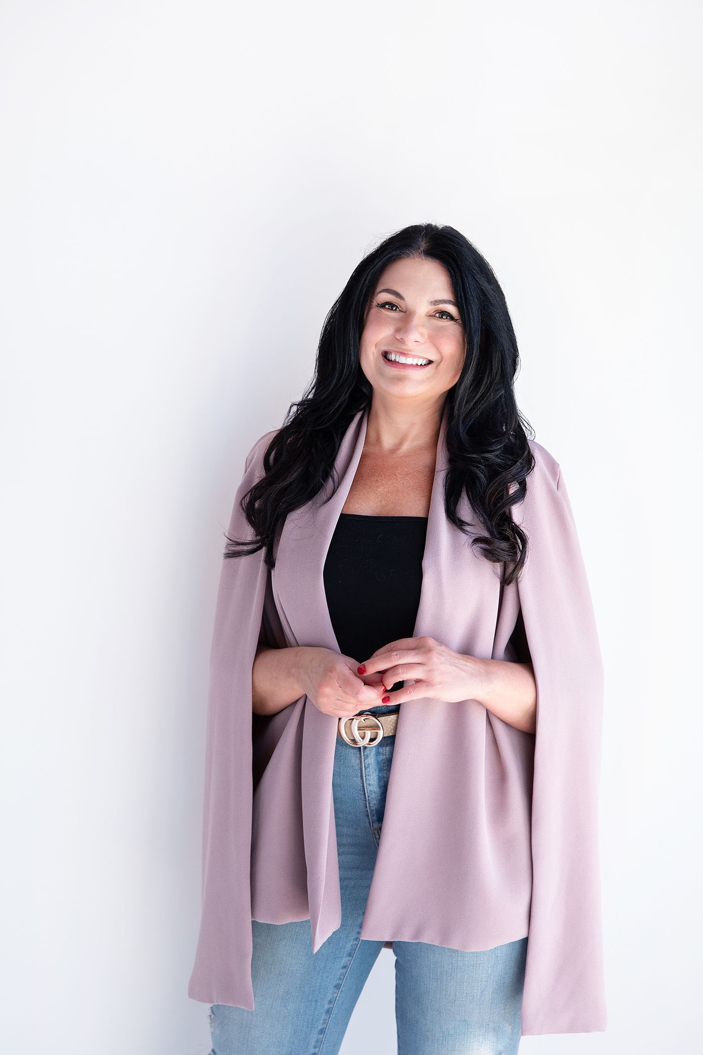 Professional fashion portraits against white background wearing pink blazer.
