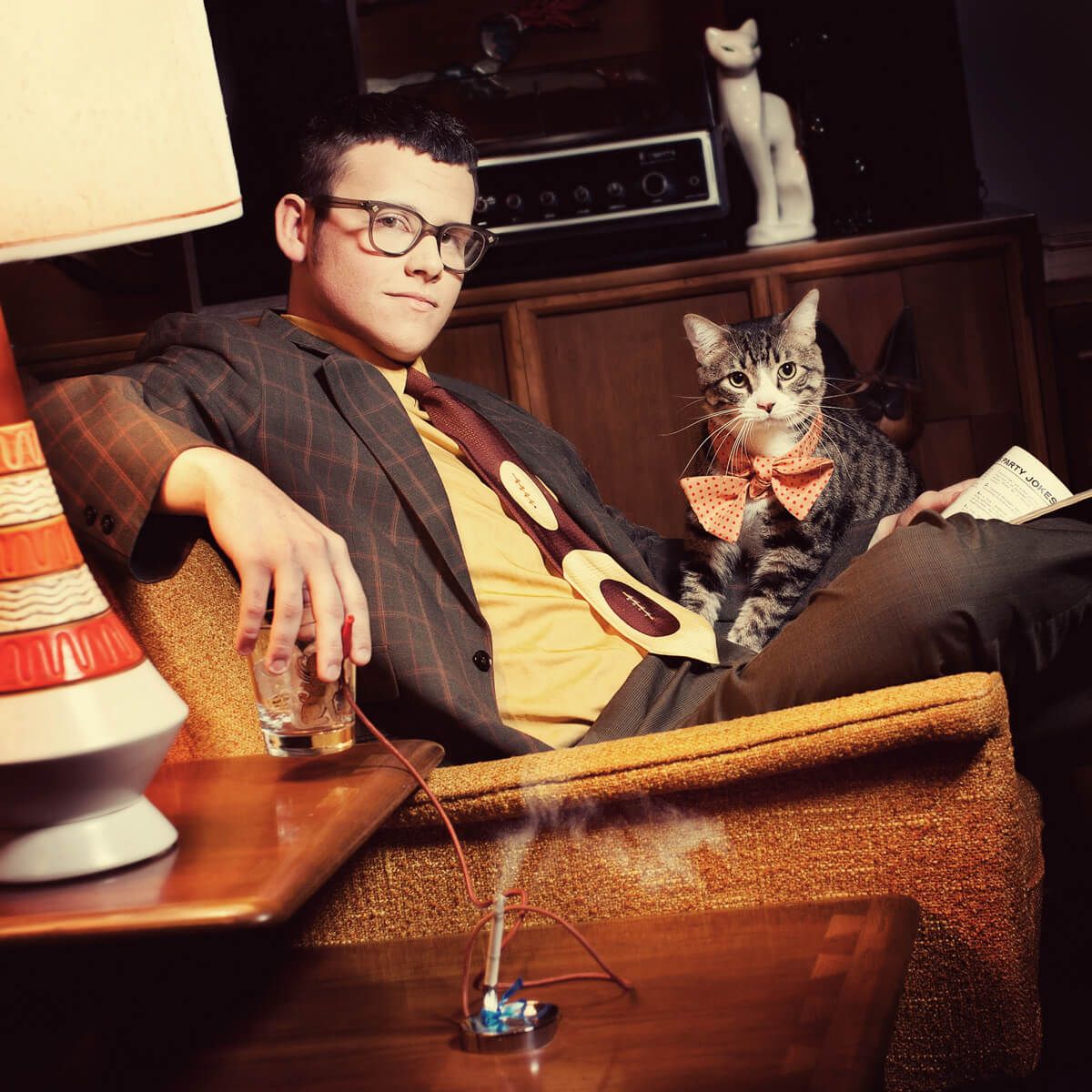 Vintage-style portrait of someone in formal wear lounging with a cat in a mid-century modern setting.