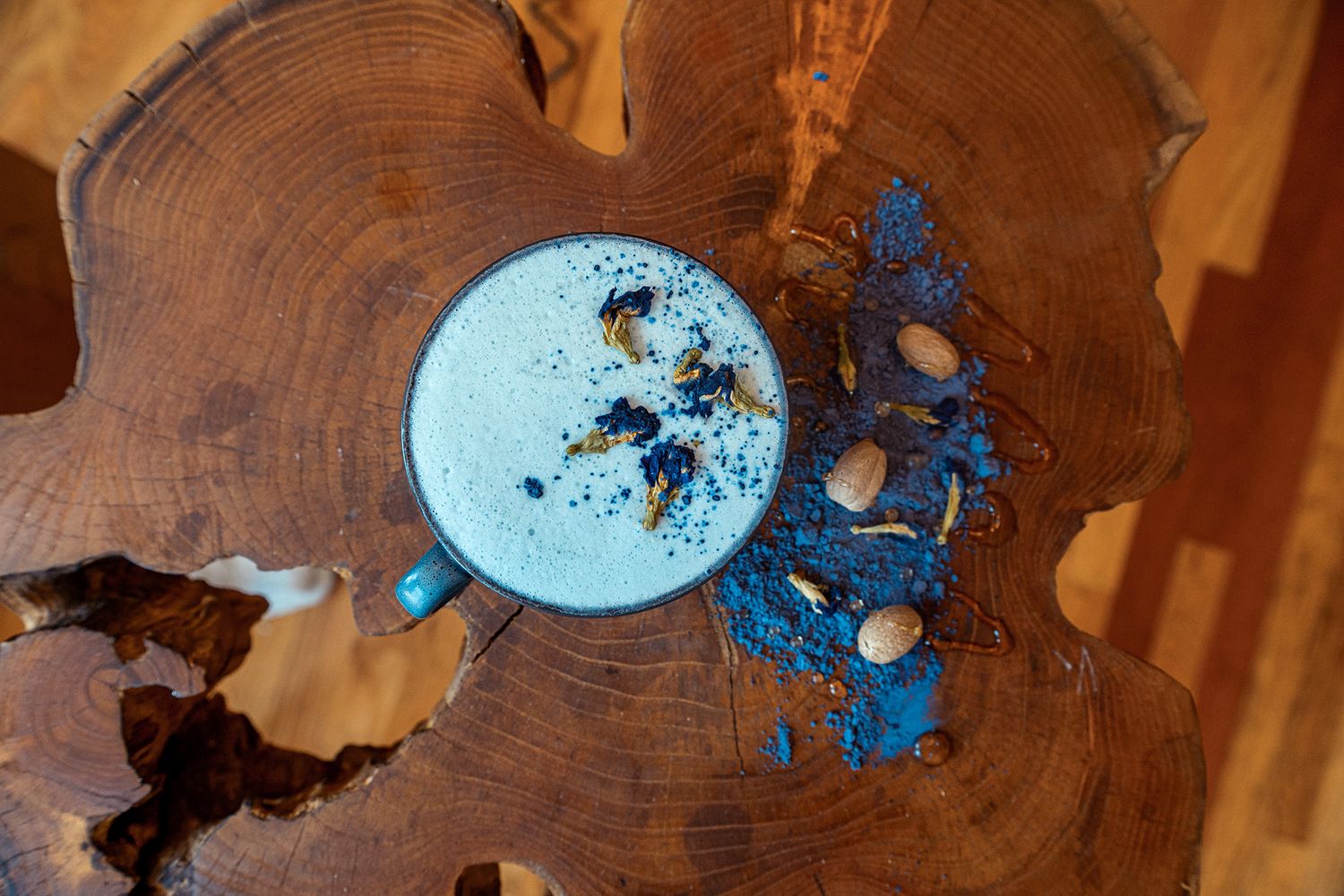 Artfully crafted wooden coaster with vibrant blue resin inlay creates a striking organic pattern design.