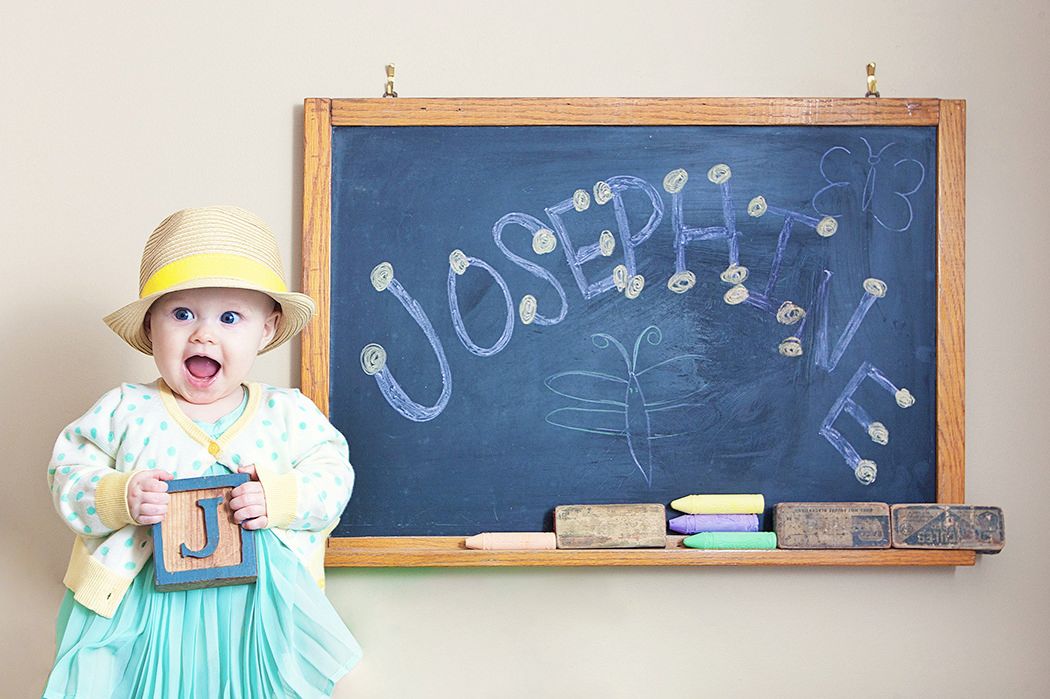 Vintage classroom with old chalkboards and wooden ledges displayed in a connected series of wall-mounted photos.