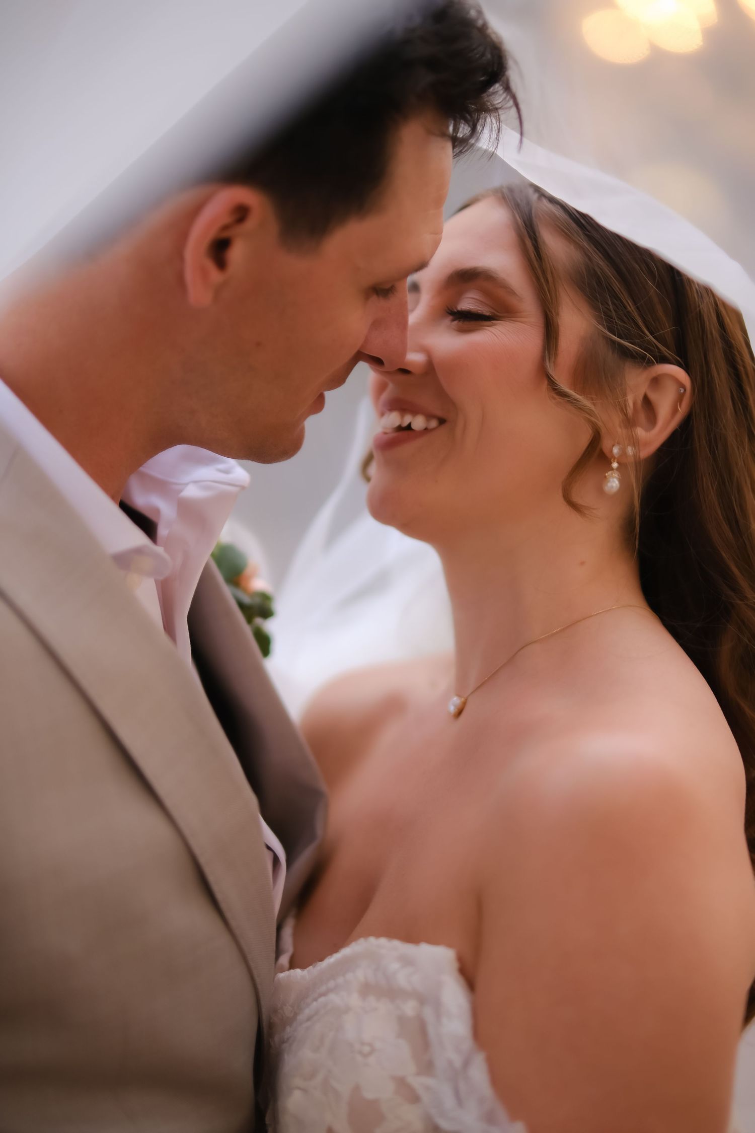 Intimate wedding moment captured in warm lighting.