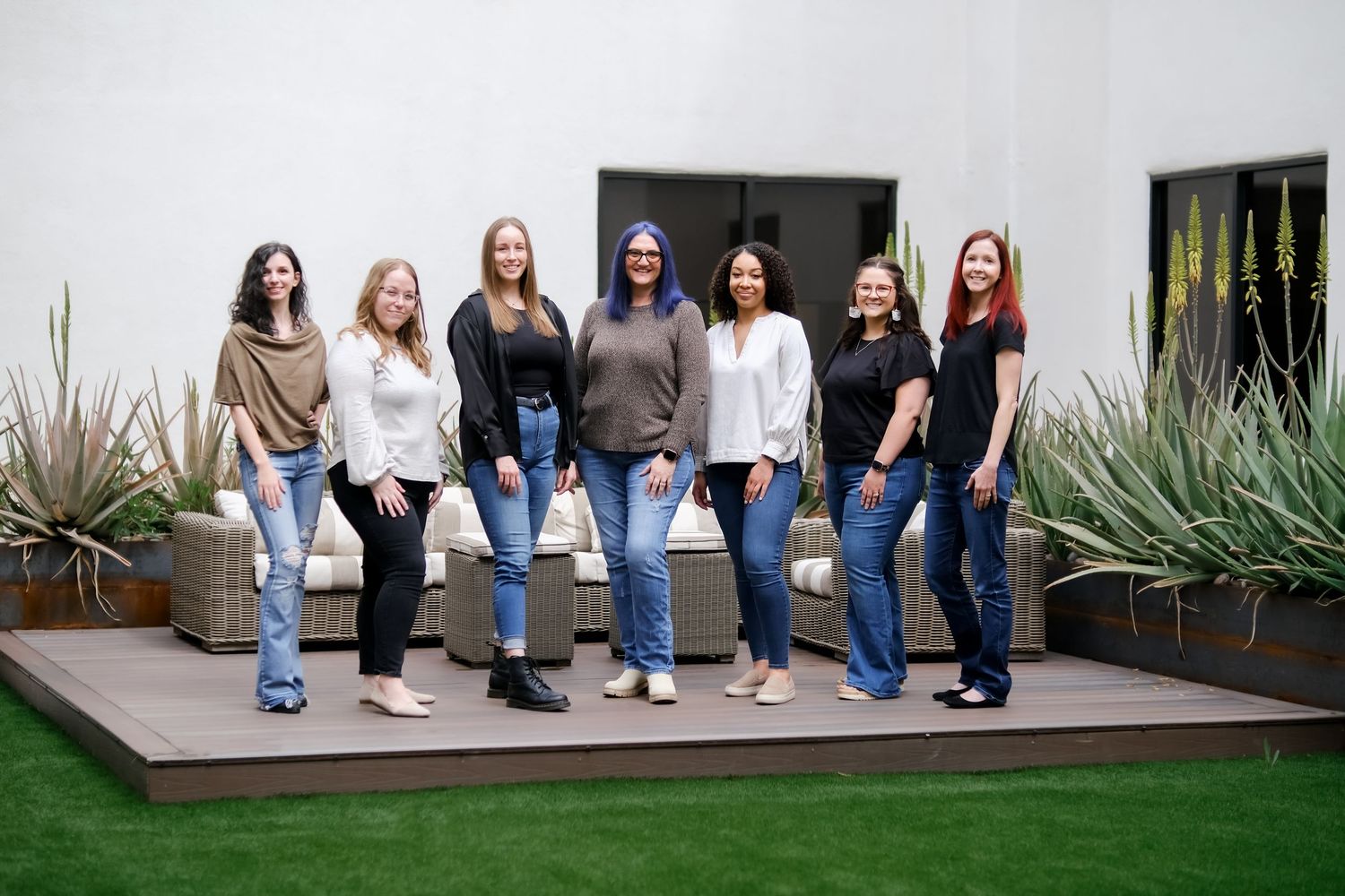 A creative panoramic collage showing people sitting on a bench in similar poses wearing blue jeans and white tops.