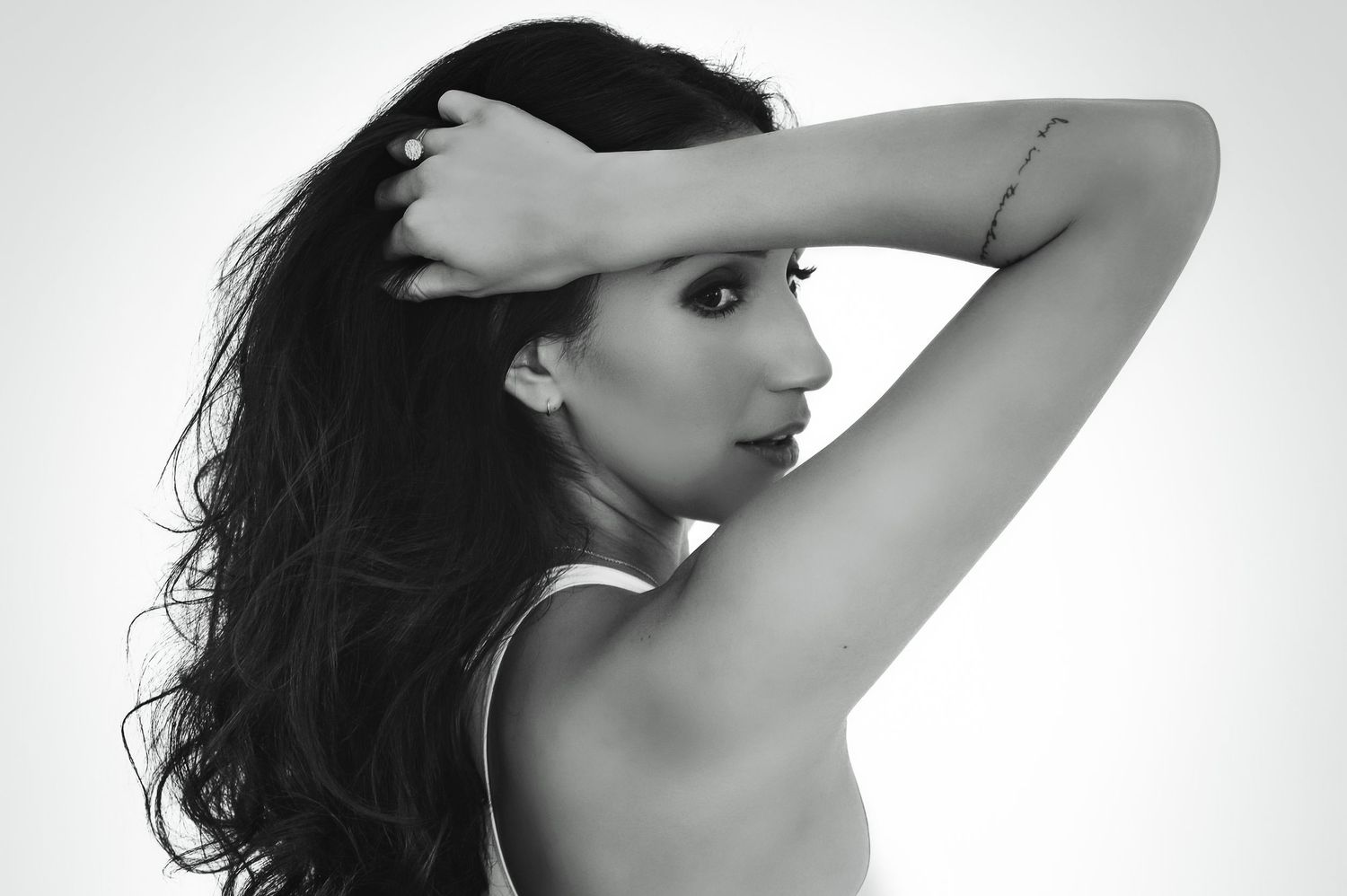 Artistic black and white portrait of a woman with flowing dark hair.