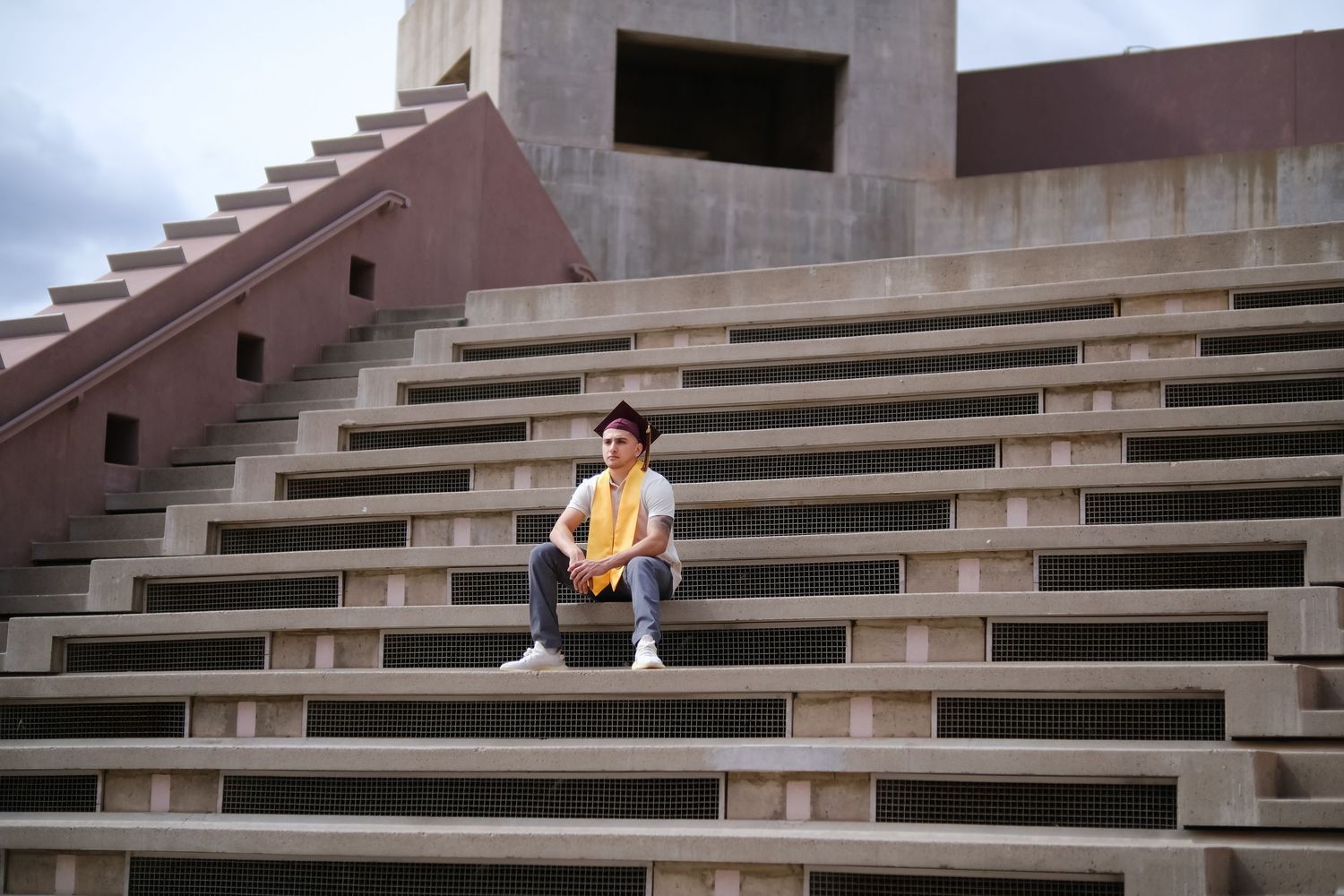 A modern terraced apartment building with a stepped architectural design features geometric lines and brown tones.