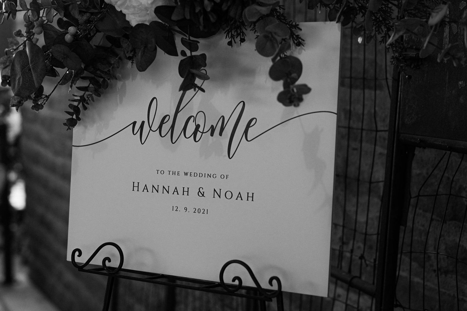 Black and white welcome sign for a wedding with elegant calligraphy and decorative details.
