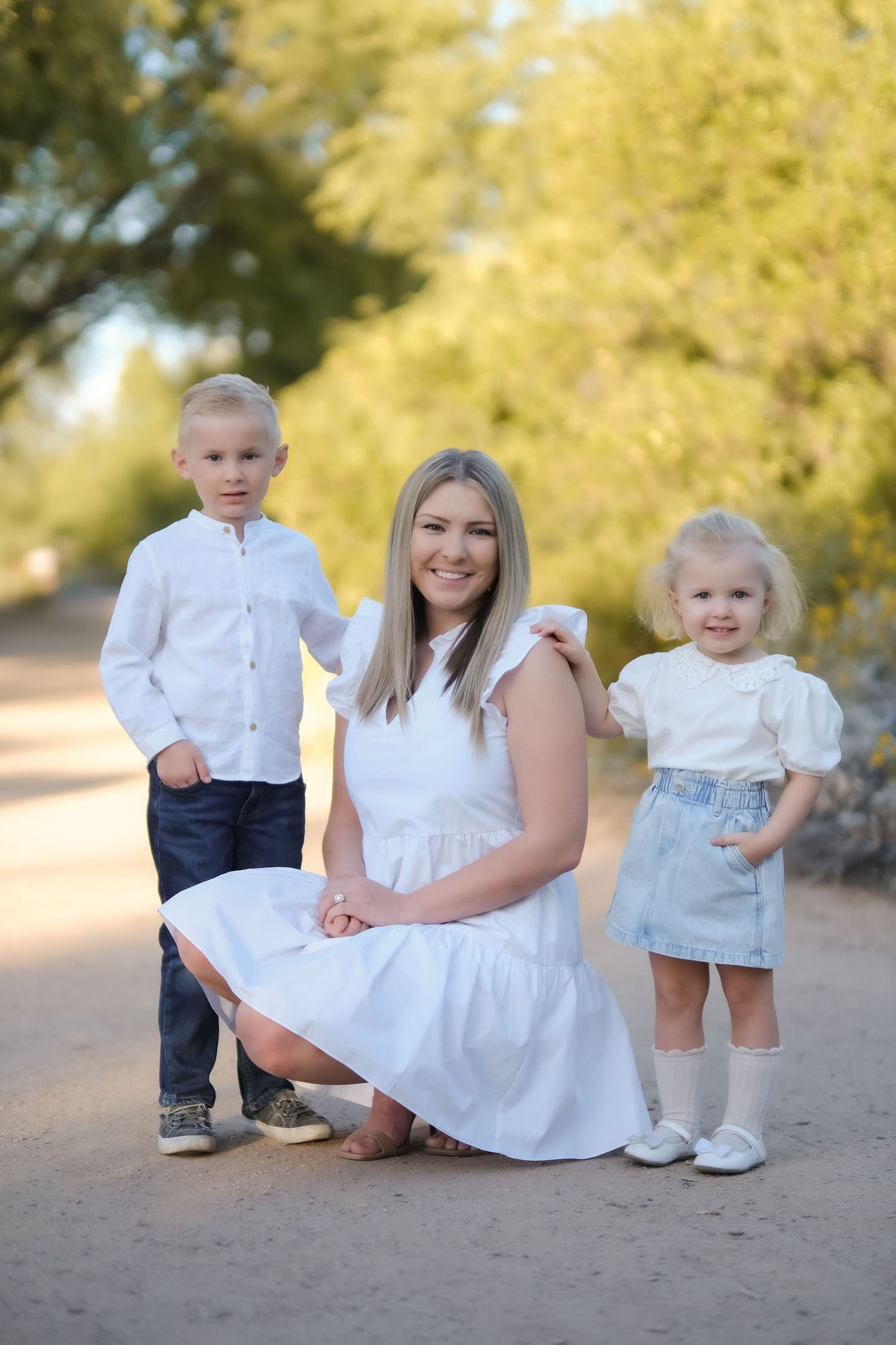 Family portrait with children on desert path with autumn foliage.