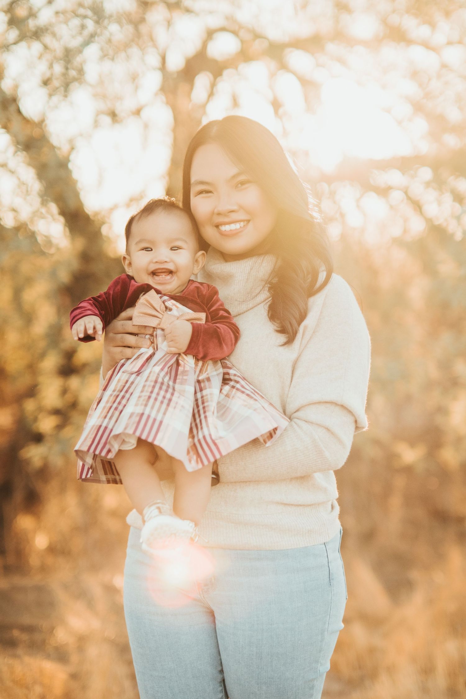 Warm sunset portrait in nature showcasing joyful parent and child moment.