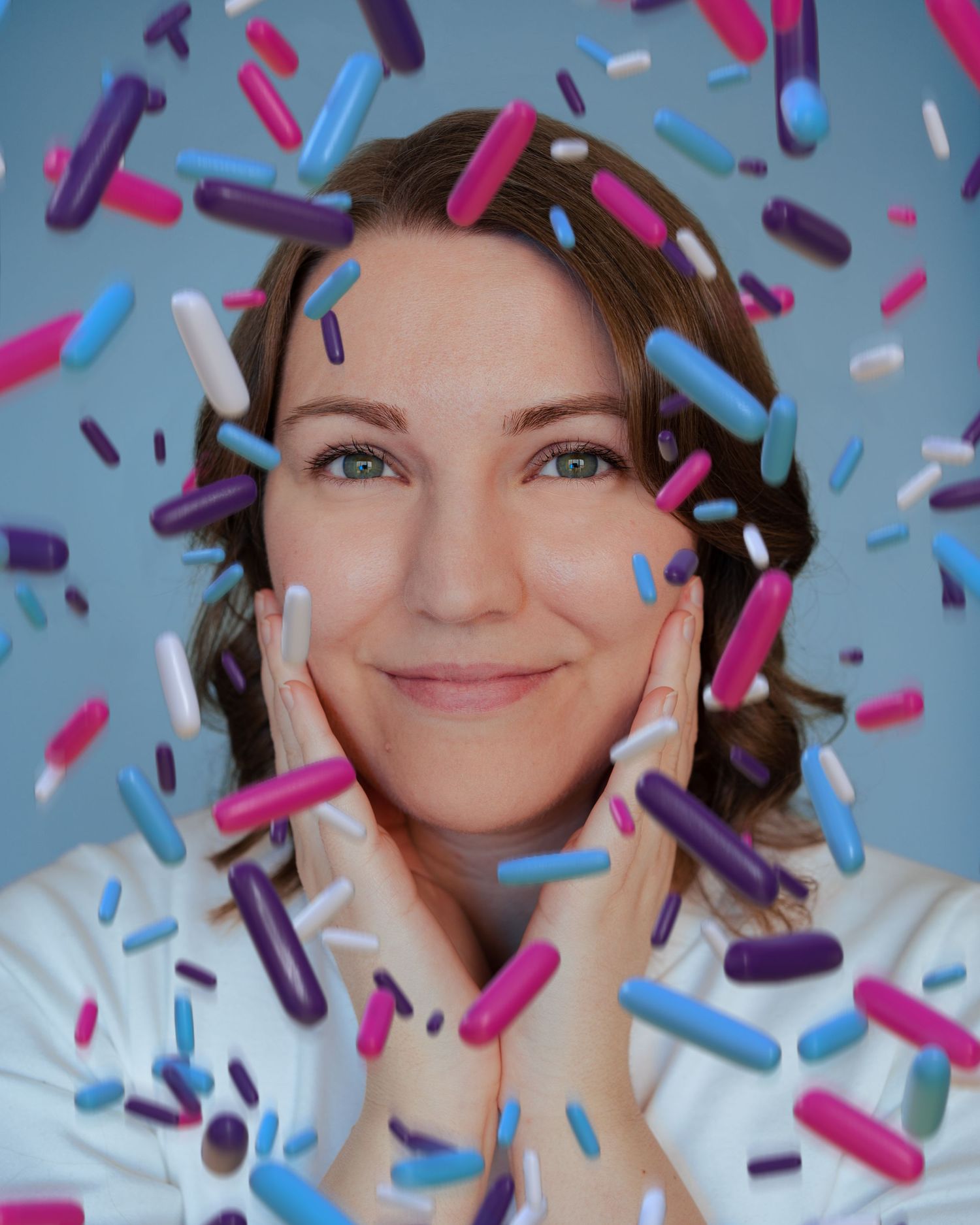 Colorful celebration scene with pink and blue confetti sprinkles against blue background.