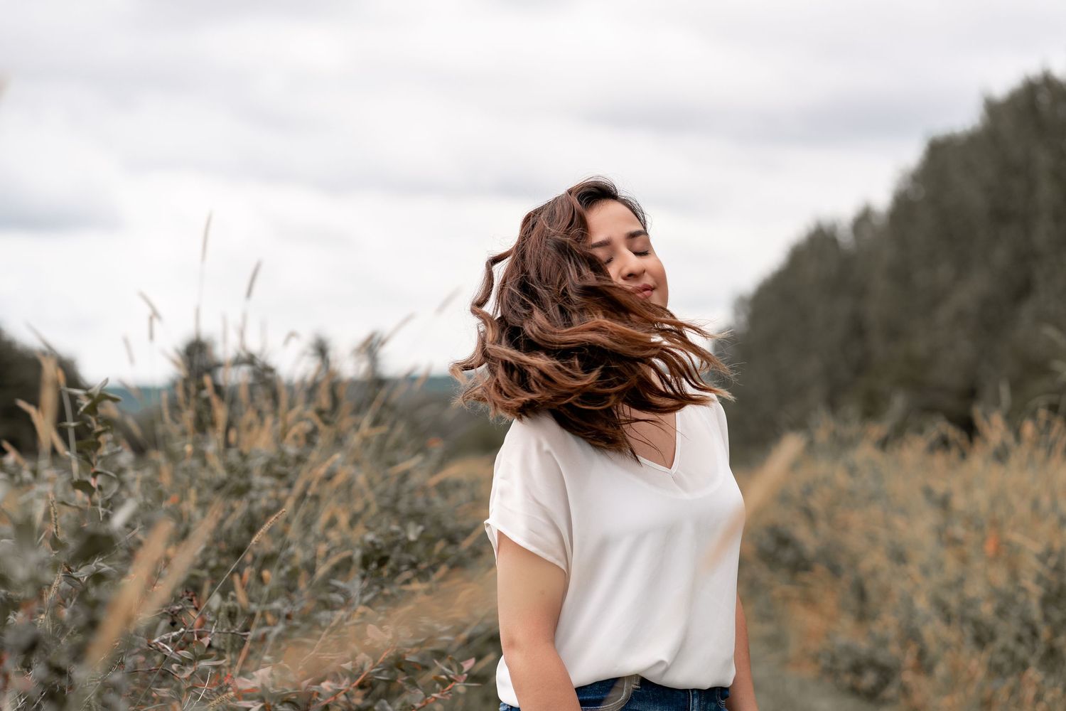 Candid outdoor portraits in natural setting with golden light and mountain landscape.