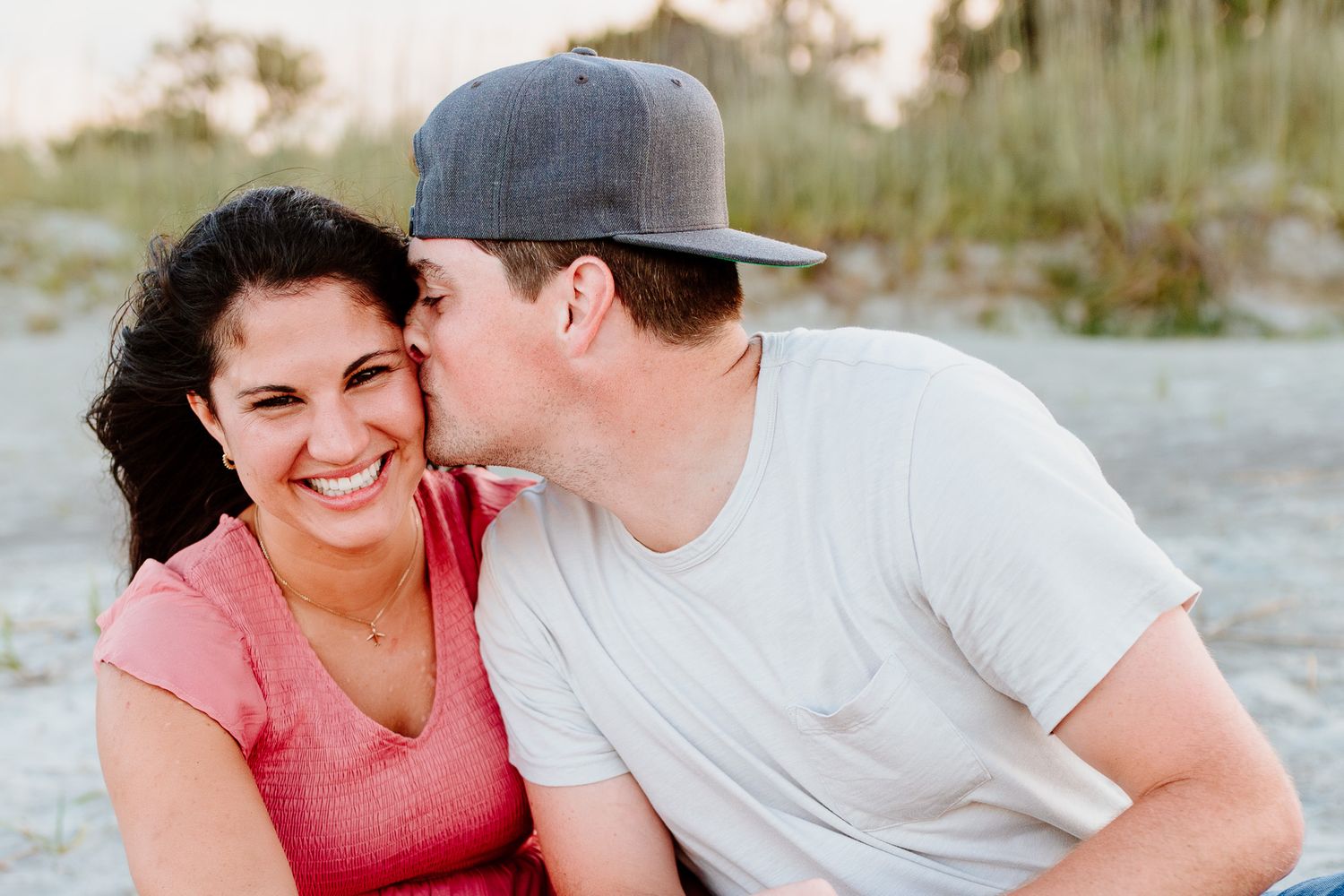 A couple shares joyful moments together outdoors in candid romantic photo series.