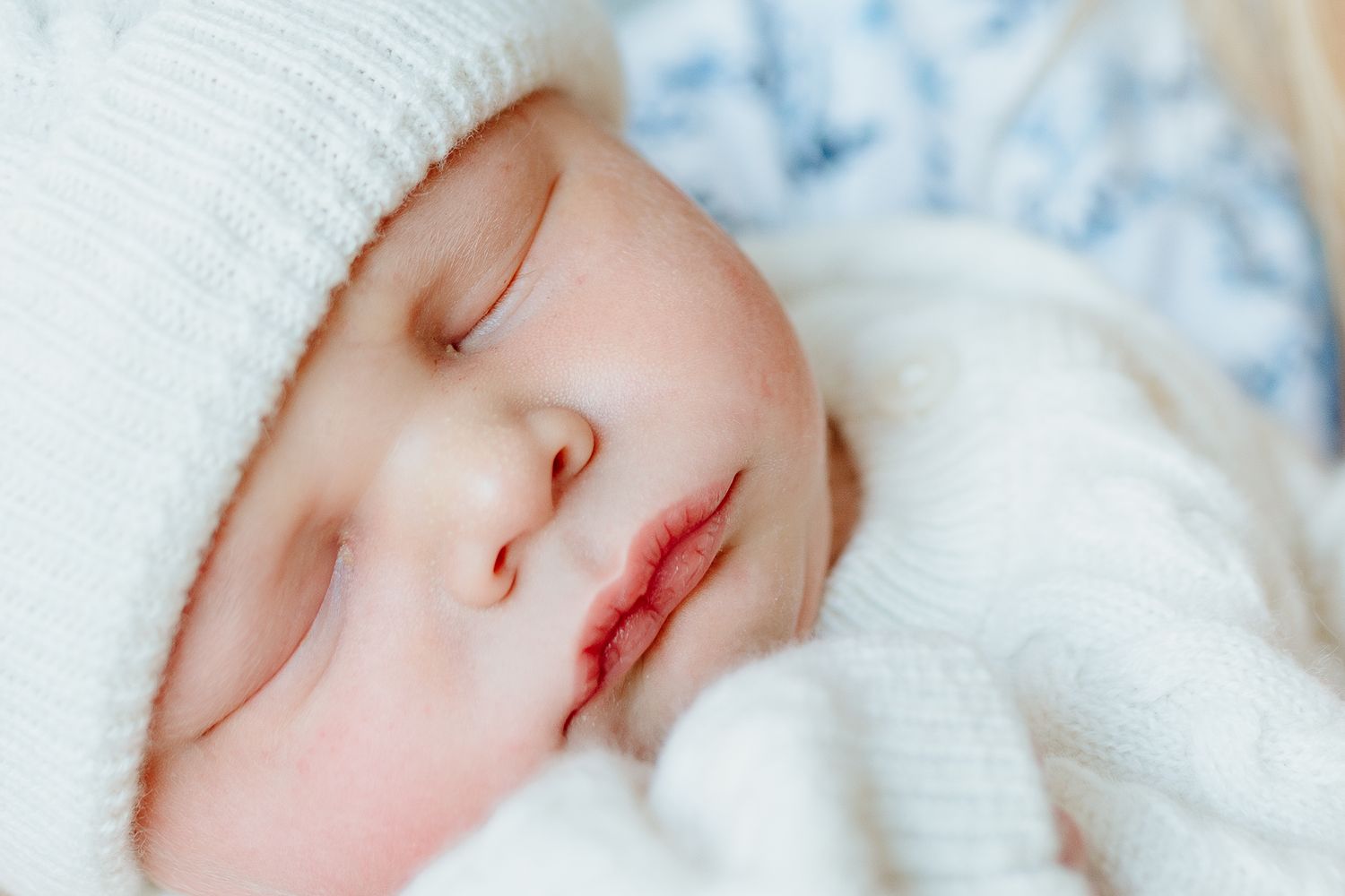 Peaceful sleeping newborn wrapped in soft white blanket. Charleston, South Carolina. Salt and Oak Photography.