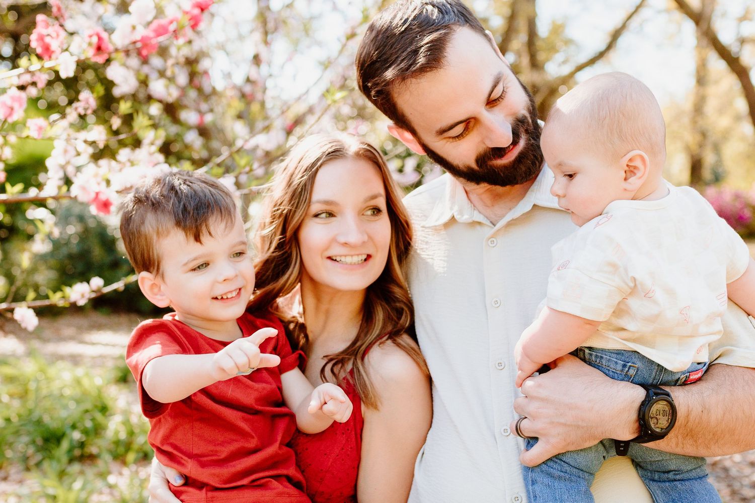 Happy family enjoying springtime outdoors with cherry blossoms. Charleston, South Carolina. Salt and Oak Photography. Hampton Park.