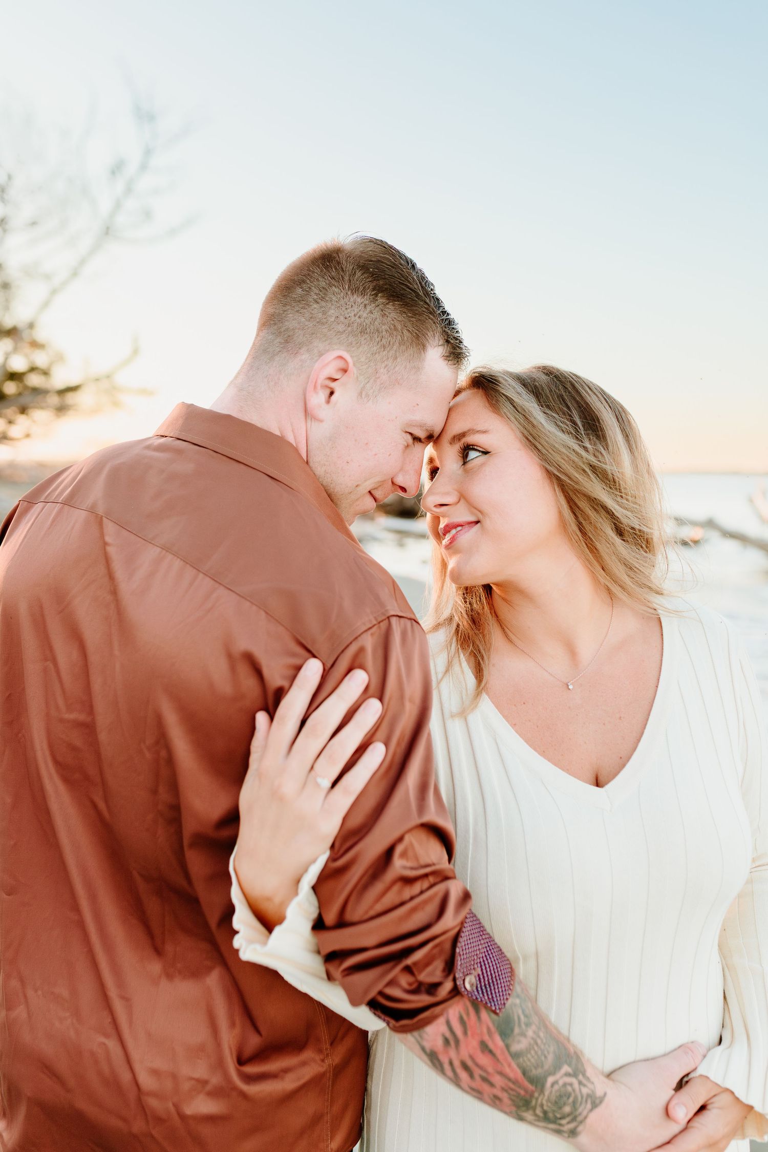 Romantic couple sharing an intimate moment at sunset on the beach. Charleston, South Carolina. Salt and Oak Photography.