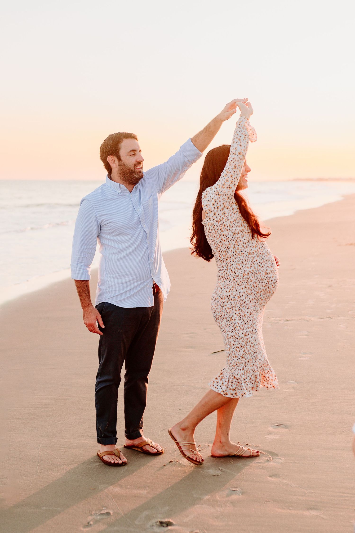 Couple dancing together on a sandy beach during golden hour. Charleston, South Carolina. Salt and Oak Photography.