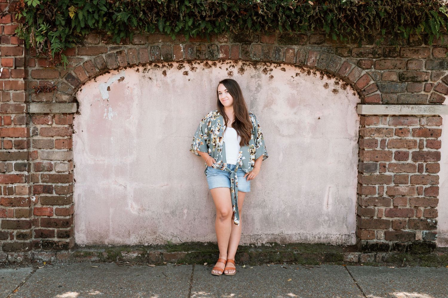 Four casual shots along an old brick wall show someone in denim shorts and a light shirt, creating retro style portraits.