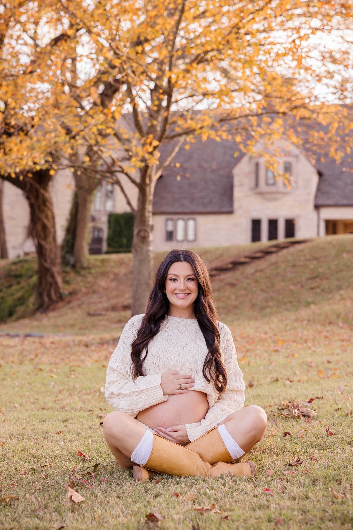Maternity photos in natural setting with fall foliage and warm autumn light.