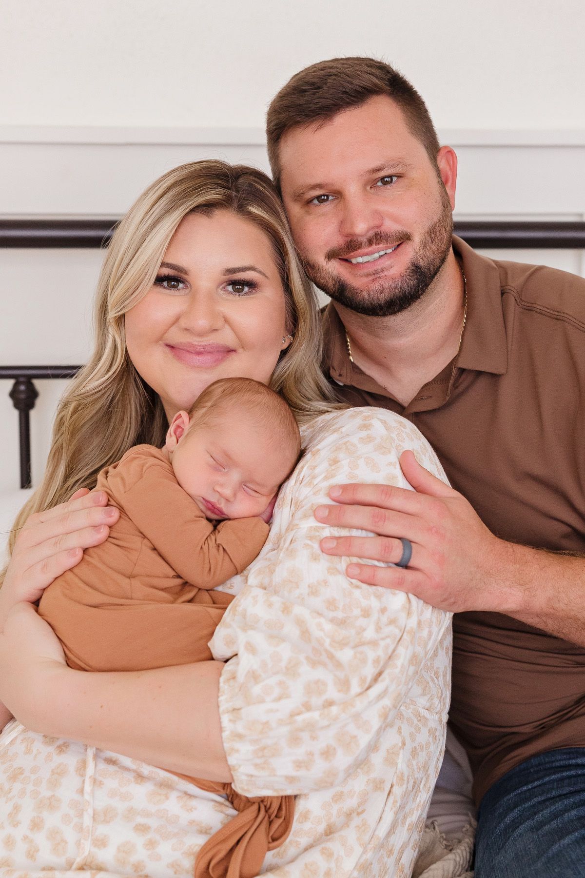 Family lifestyle portraits with newborn baby in modern neutral-toned setting.