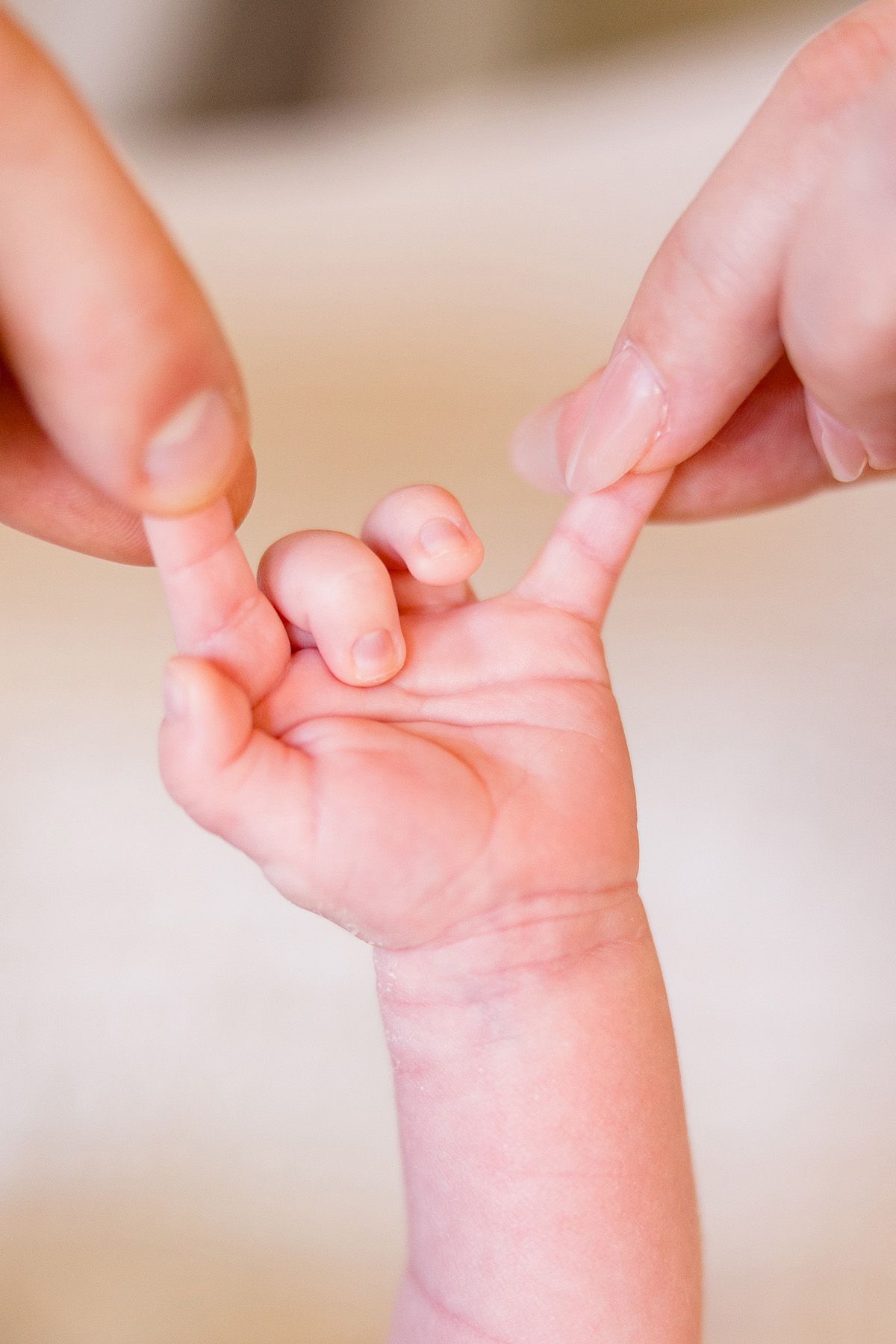 Detailed shots of a newborn baby's delicate hands and fingers.