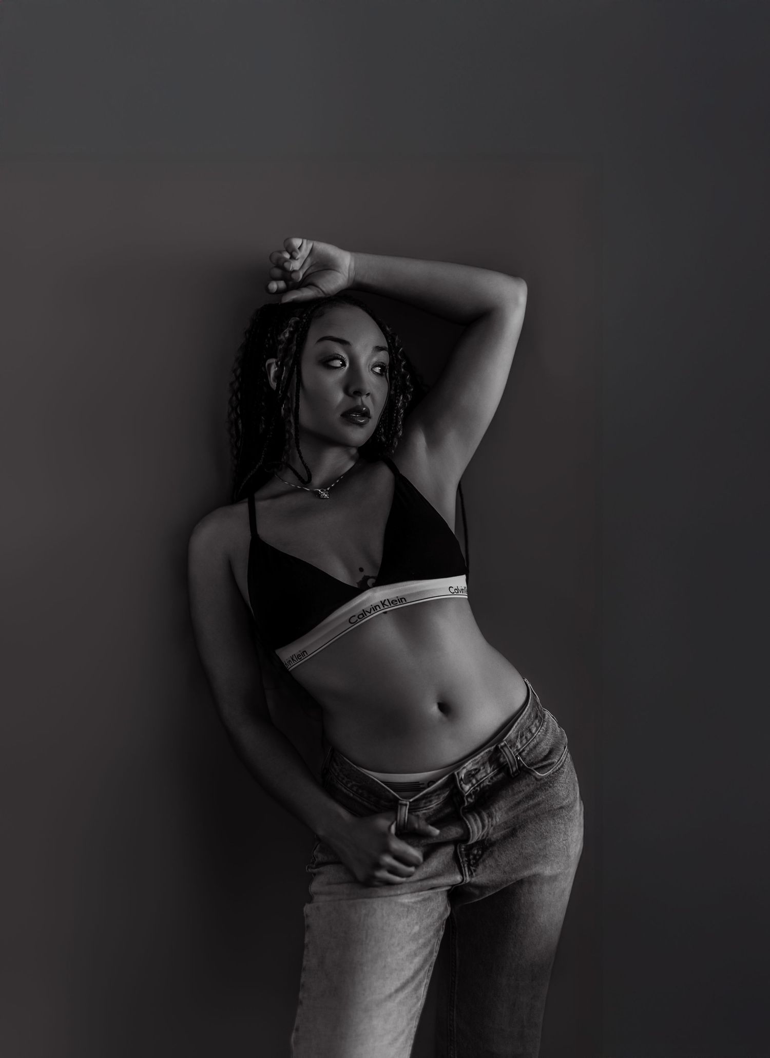 Black and white artistic boudoir photo series showing silhouetted feminine figure in dramatic poses against dark background.