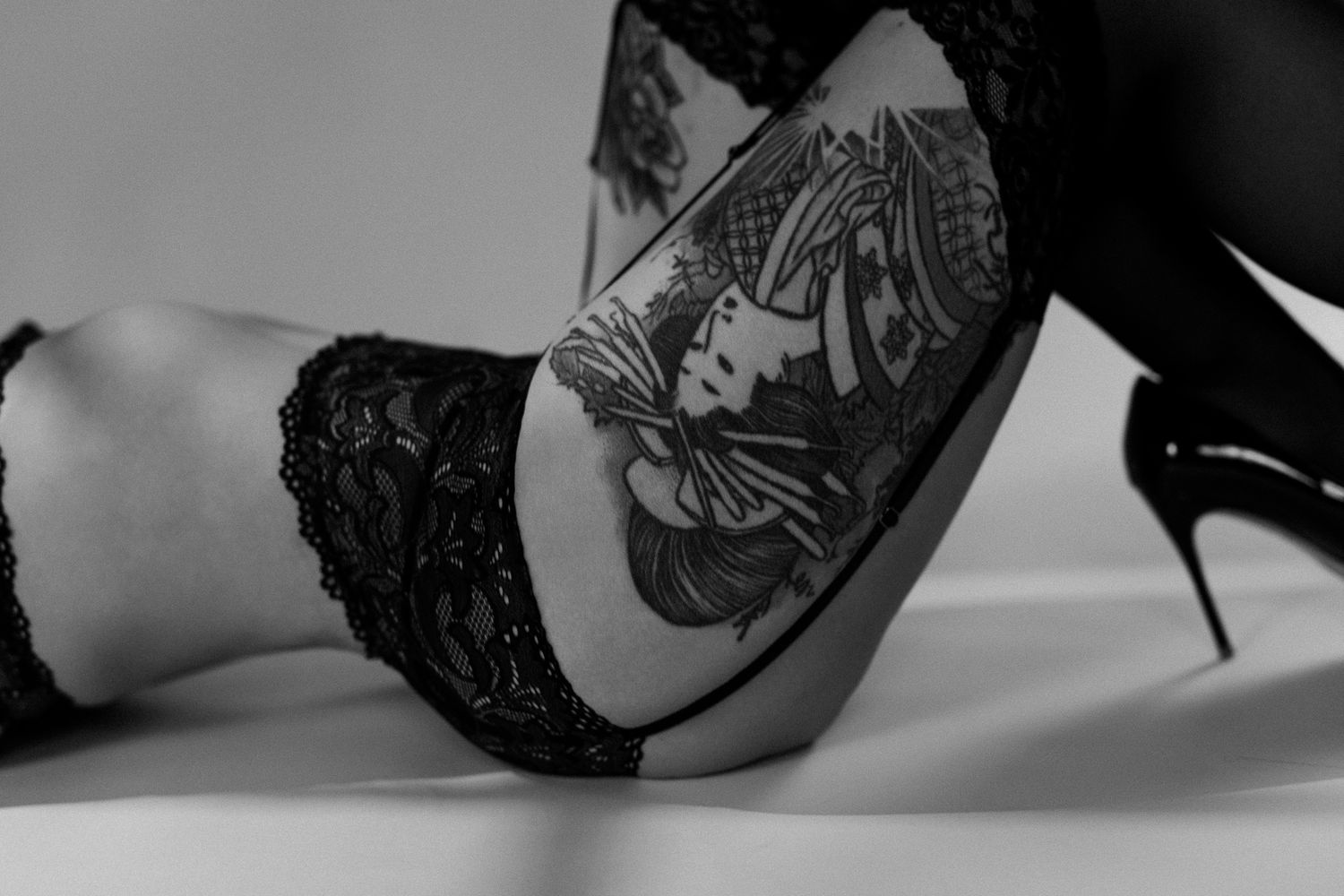 Elegant black lace heels with delicate embroidery details arranged in a stylish fashion photography layout.