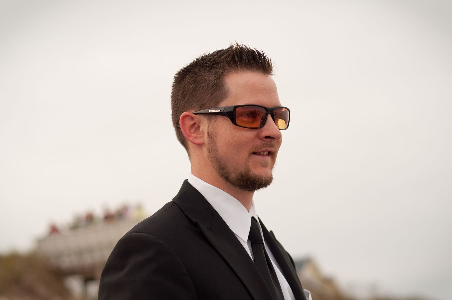 Portrait of a cool guy wearing sunglasses in a suit