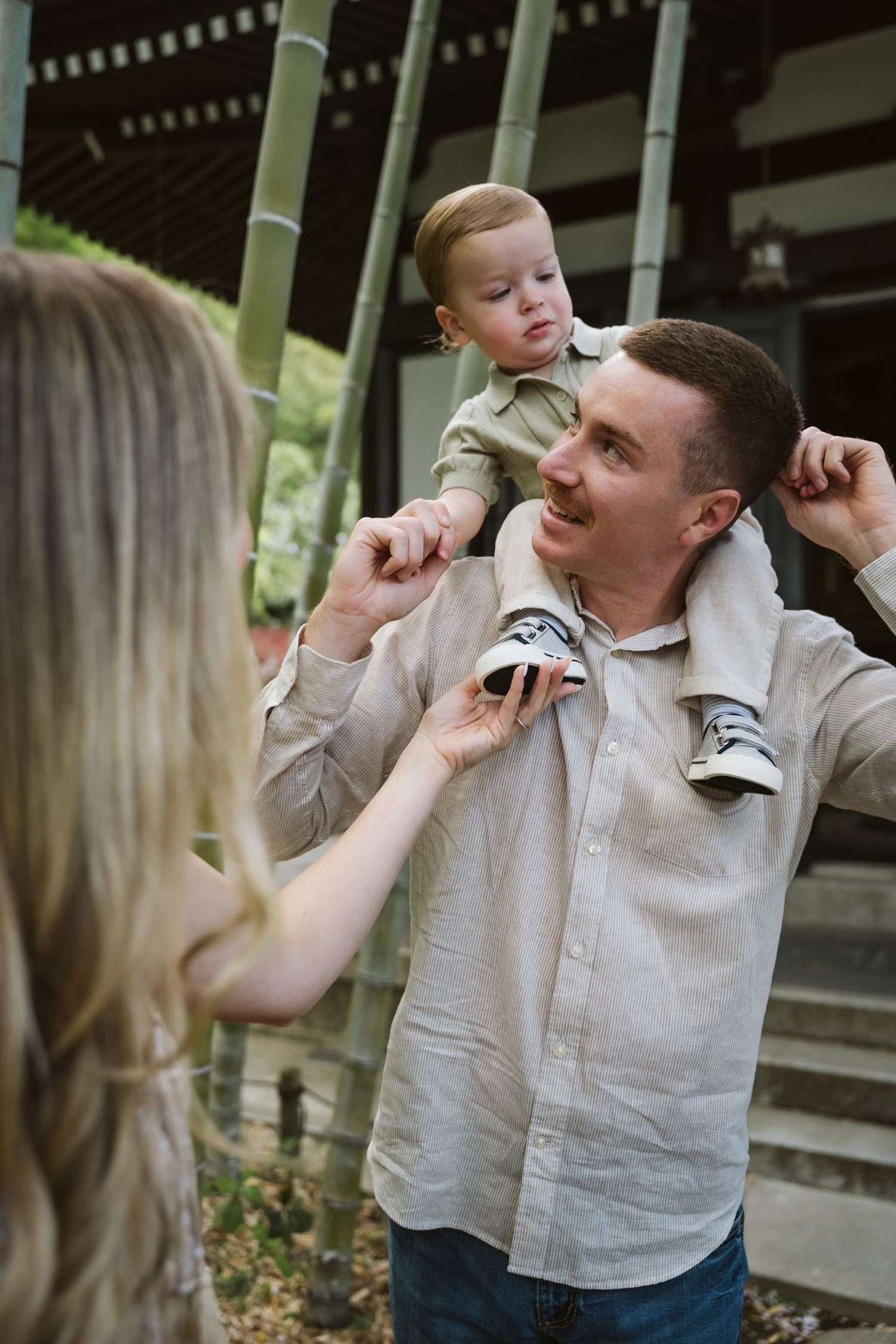 Playful candid moments captured between couple at Japanese temple garden.