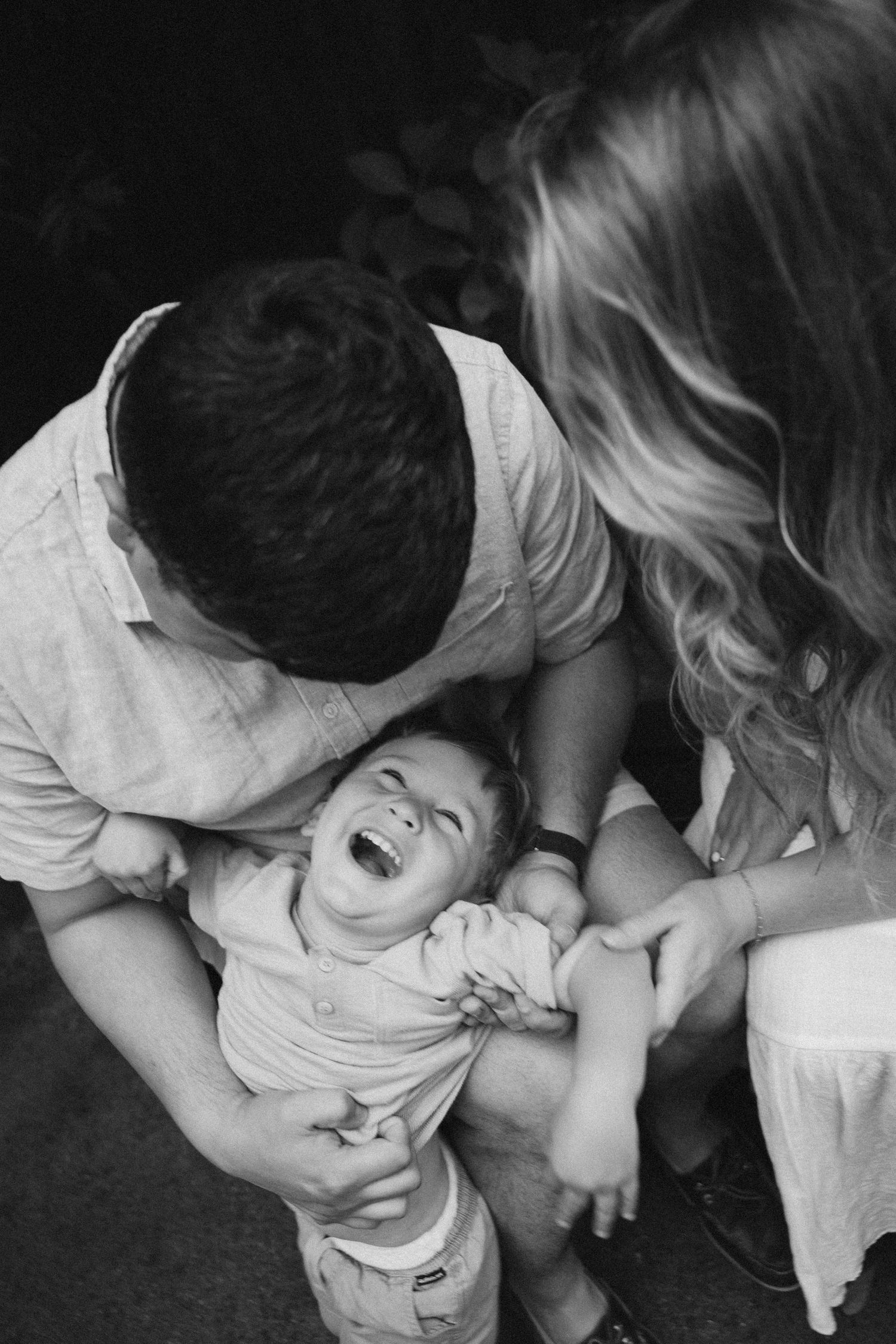 Black and white sequence showing tender moments between a parent and child in close-up.
