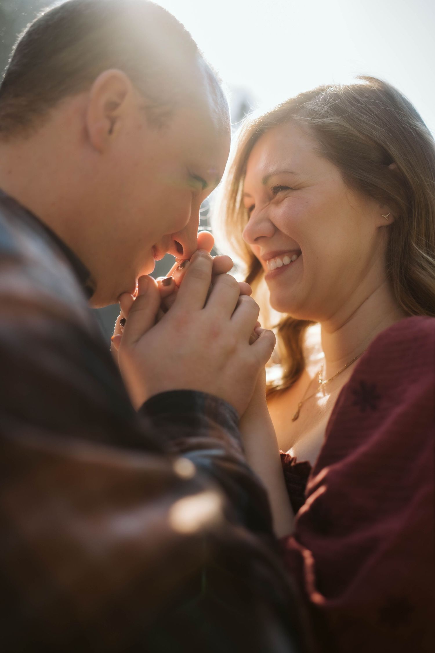 Romantic couple photos in warm sunlight showing tender moments and genuine happiness between them.