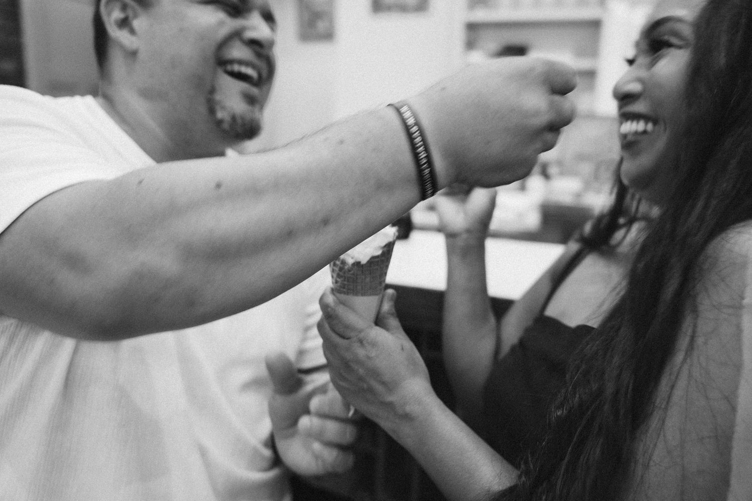 Black and white photo series showing intimate moments between a couple embracing and kissing.