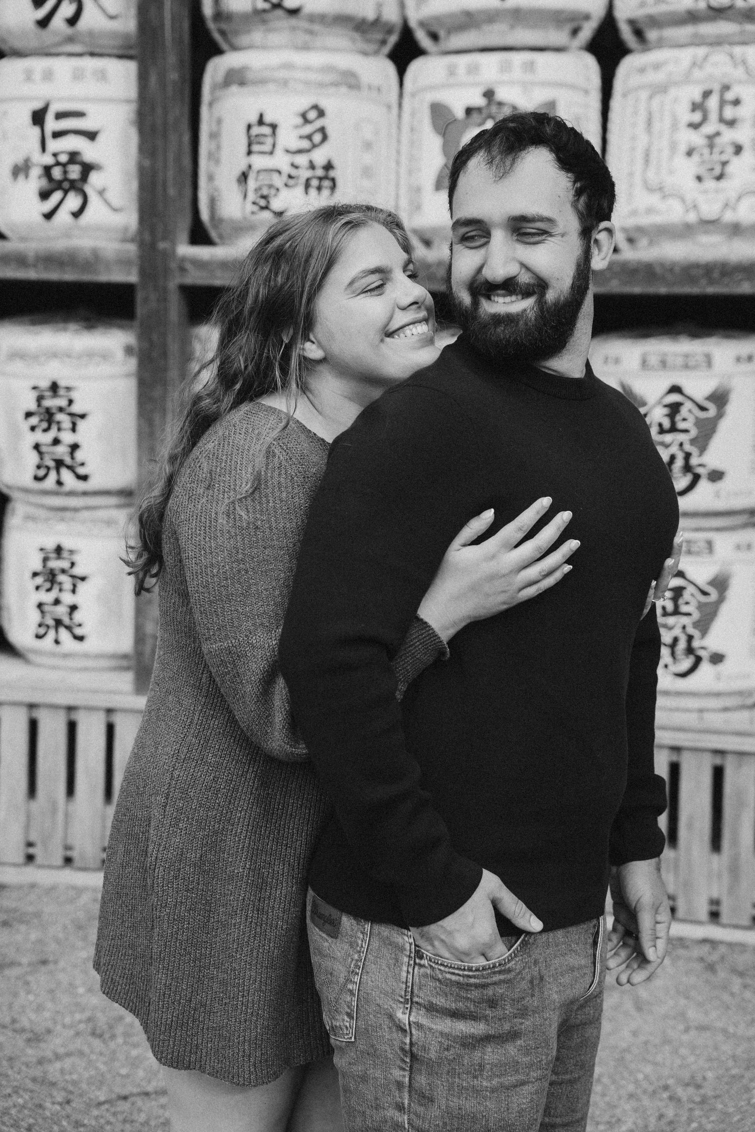 A romantic black and white photo series showing an intimate embrace against a backdrop of Japanese lanterns.