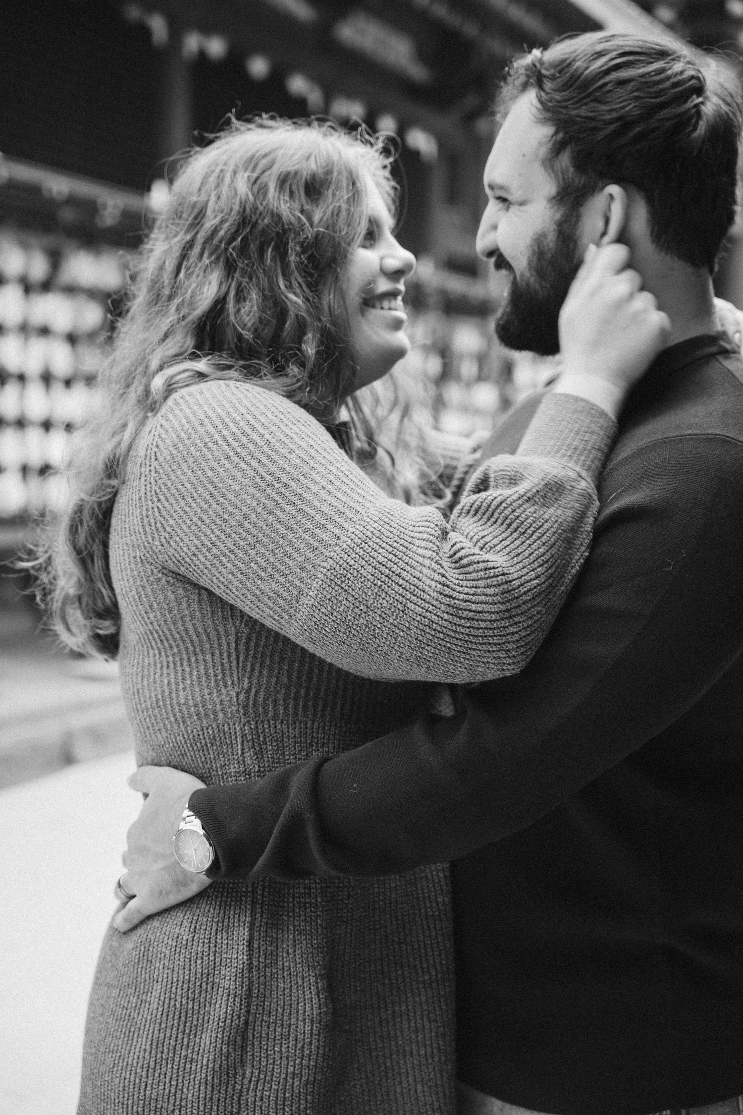 Black and white photo series showing a couple in an intimate embrace with one wearing a knit sweater.
