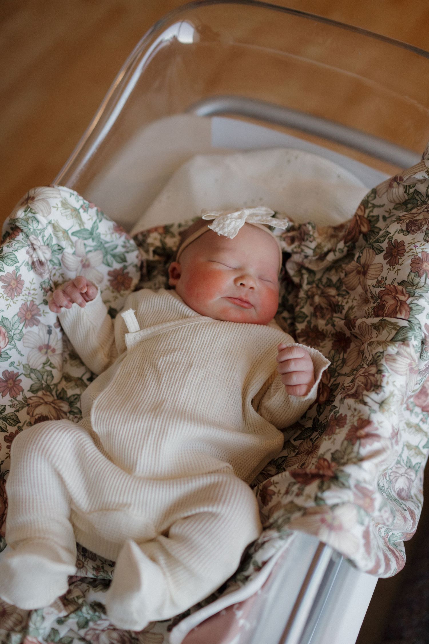 A newborn baby sleeping peacefully in a hospital bassinet in a fresh 48 session.