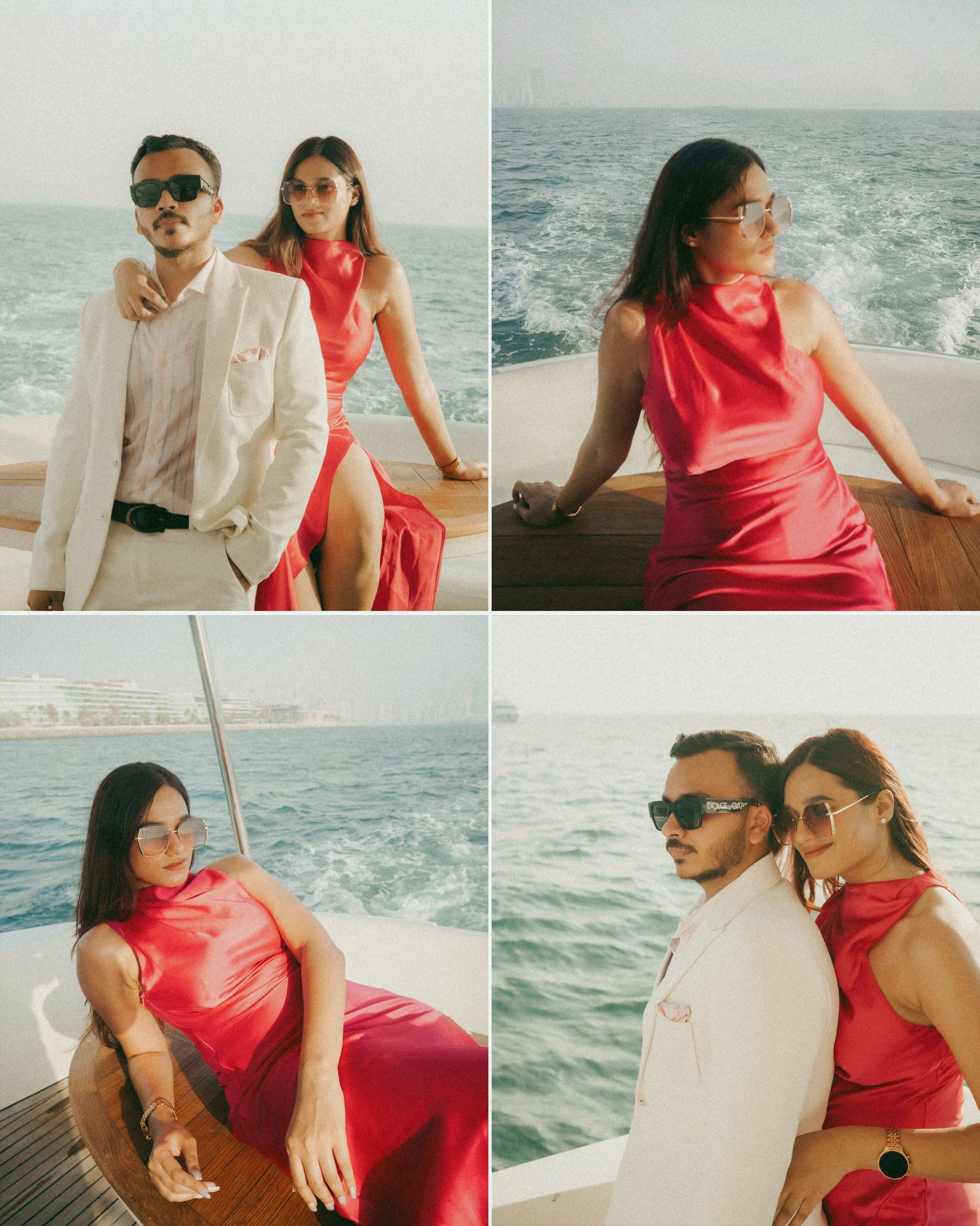 Couple posing on a luxury yacht, woman in red satin dress and man in white suit, with ocean views in background.