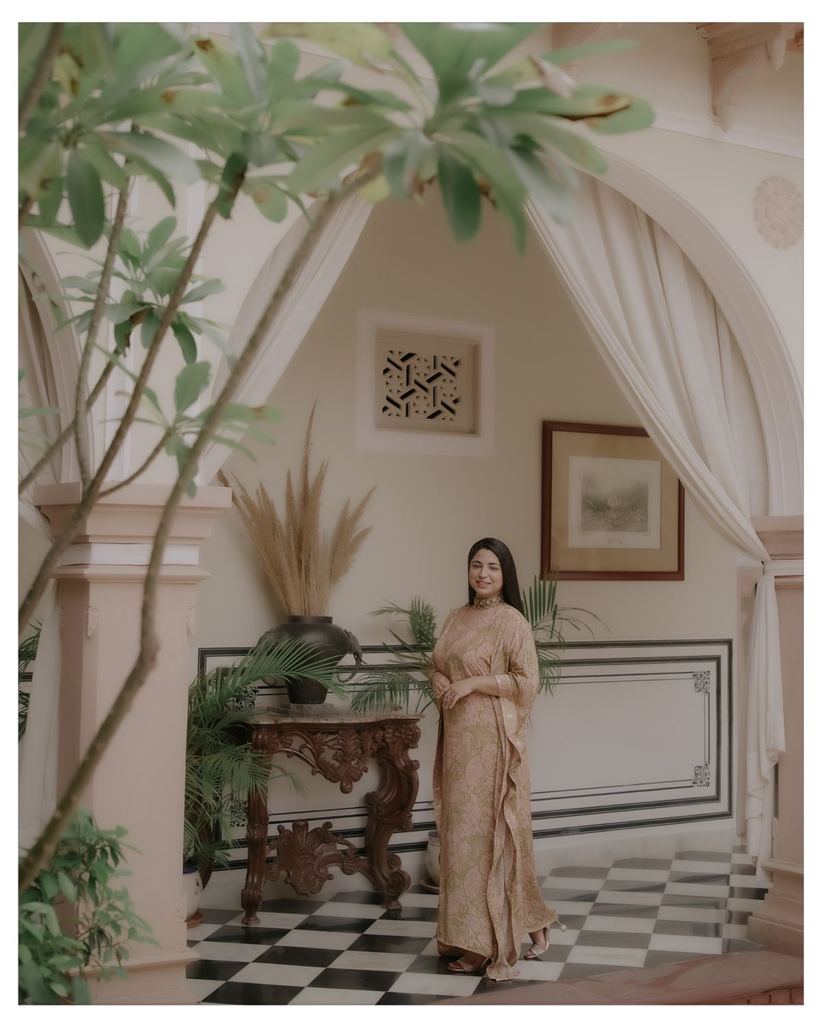 Classic interior featuring white arches, geometric flooring patterns and traditional decor elements.