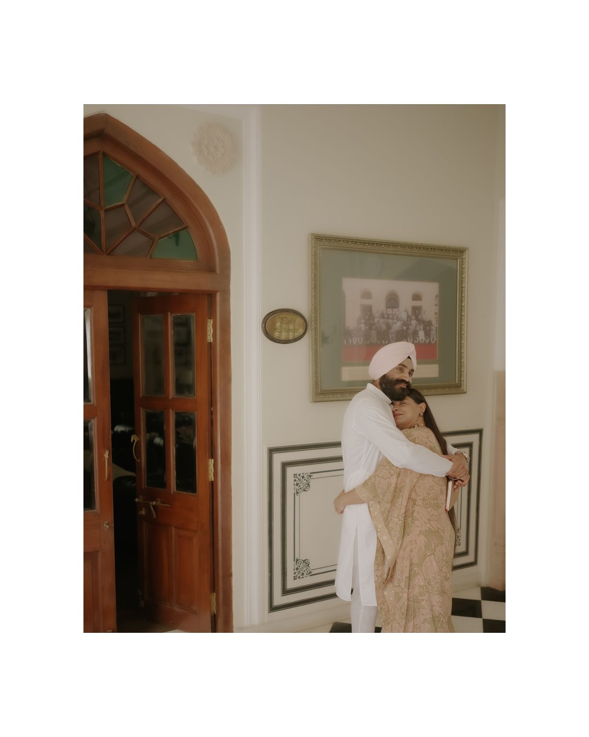 Vintage-style interior with arched wooden doorway and black and white tiled flooring.