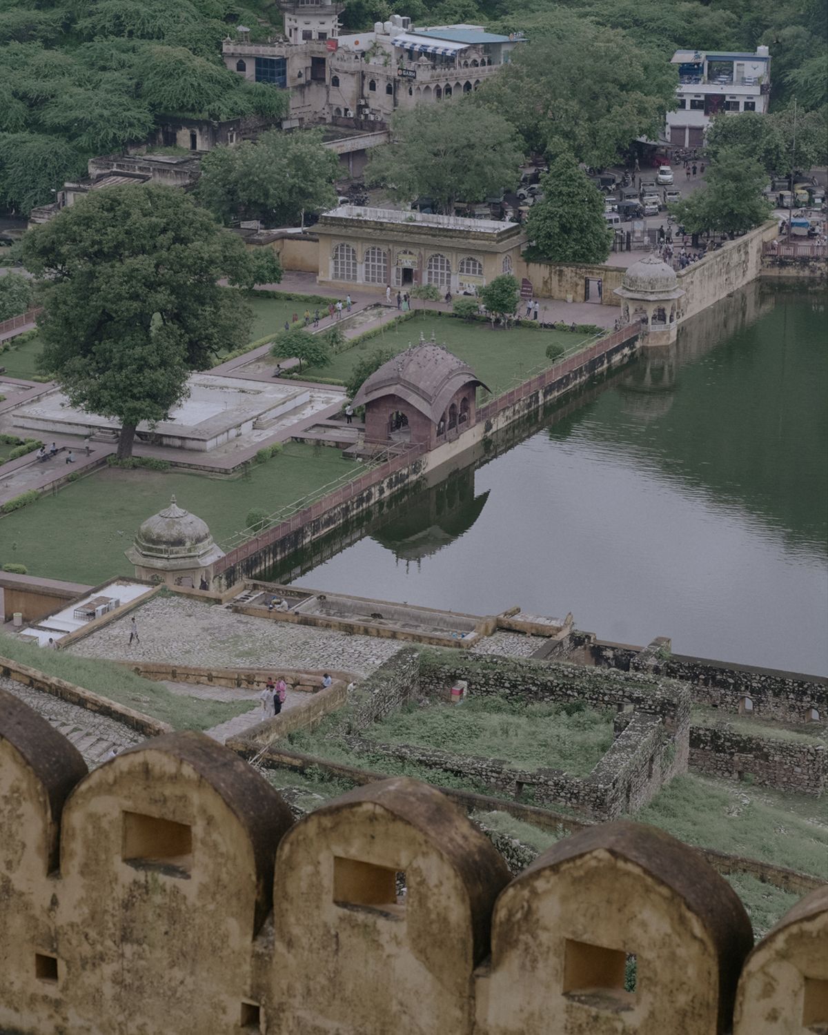 Aerial view of a historic fort complex with gardens and water features surrounded by lush greenery.