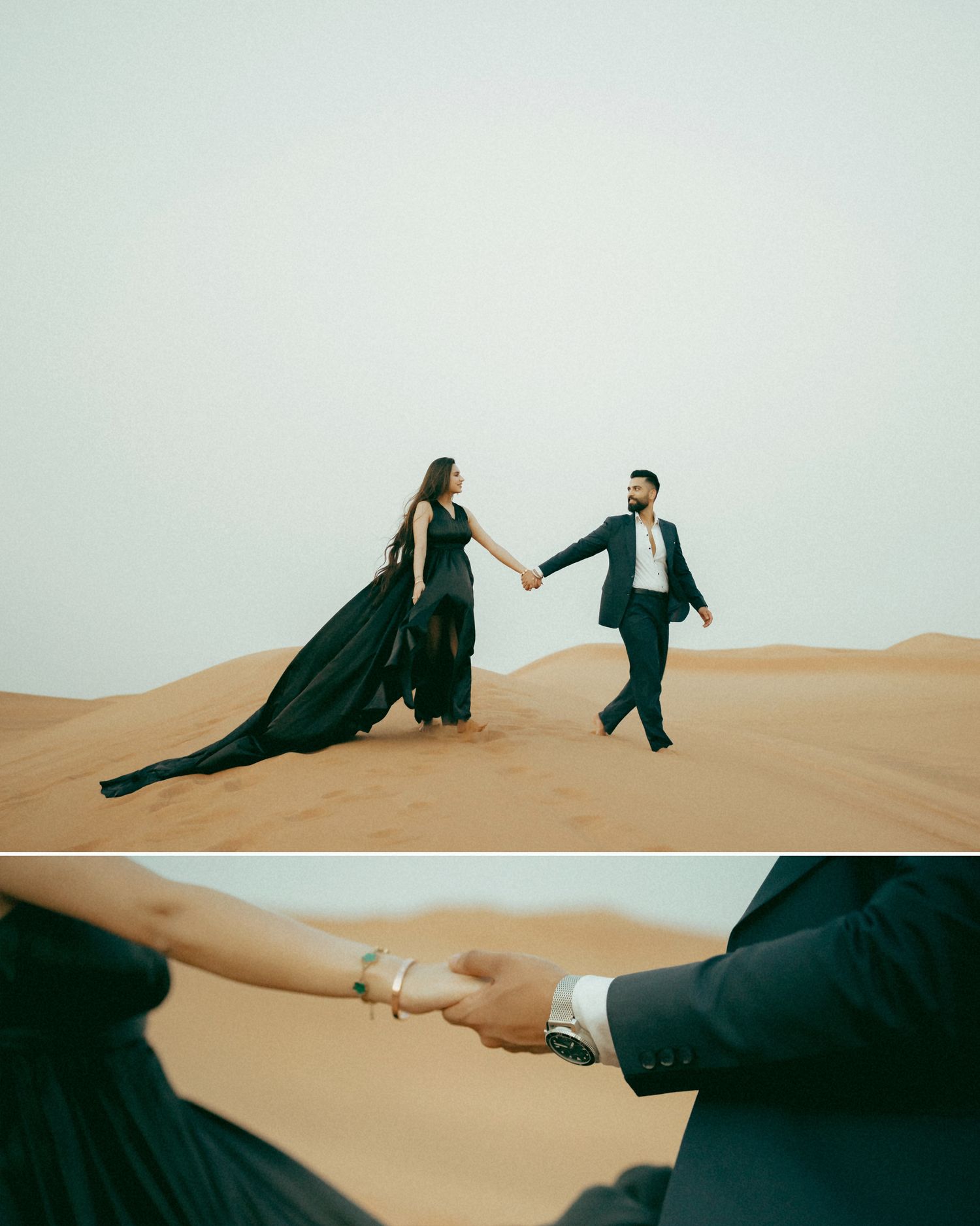 Couple in elegant black attire holding hands on golden sand dunes in a desert landscape.