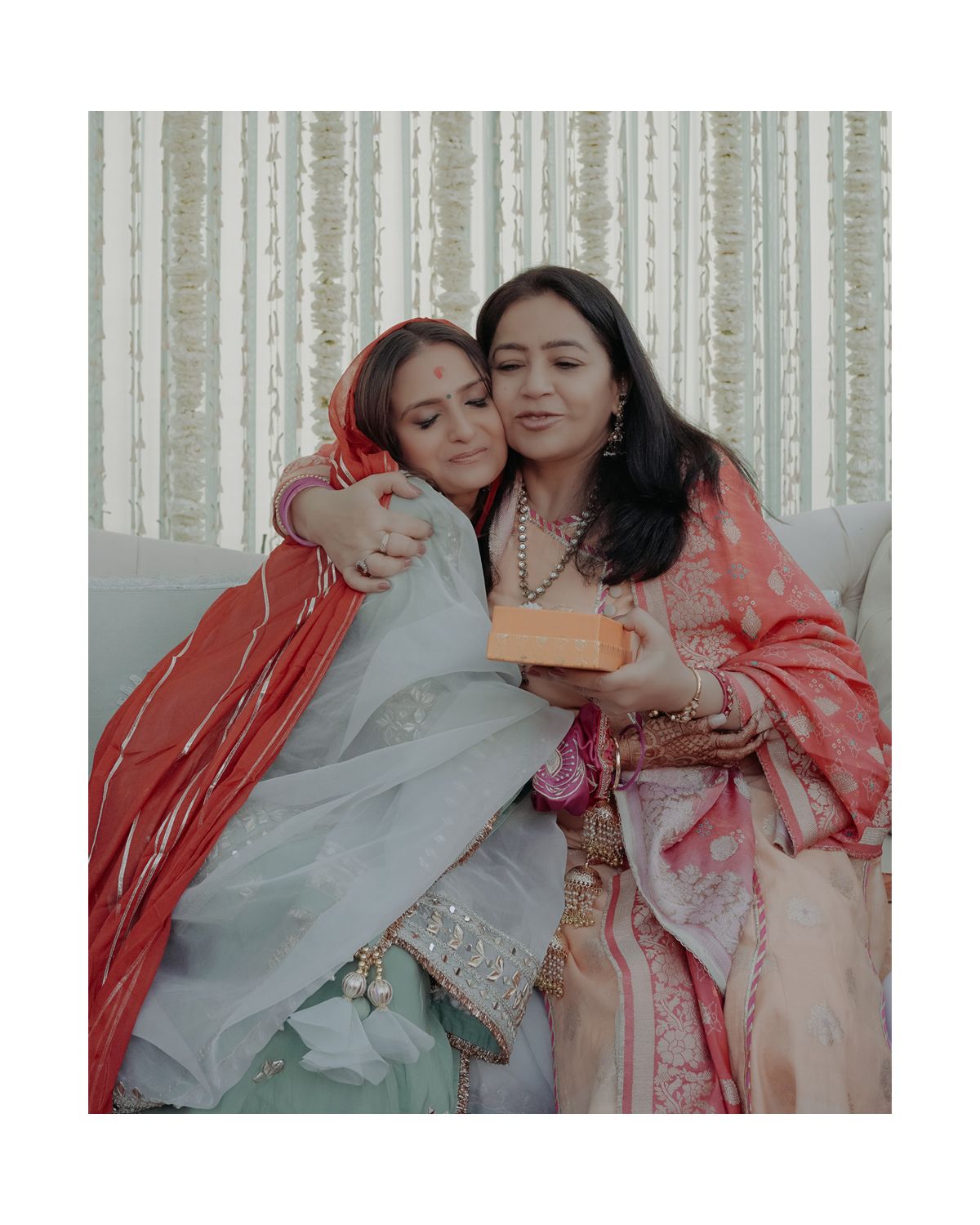 Two guests share an emotional moment during a traditional wedding ceremony.
