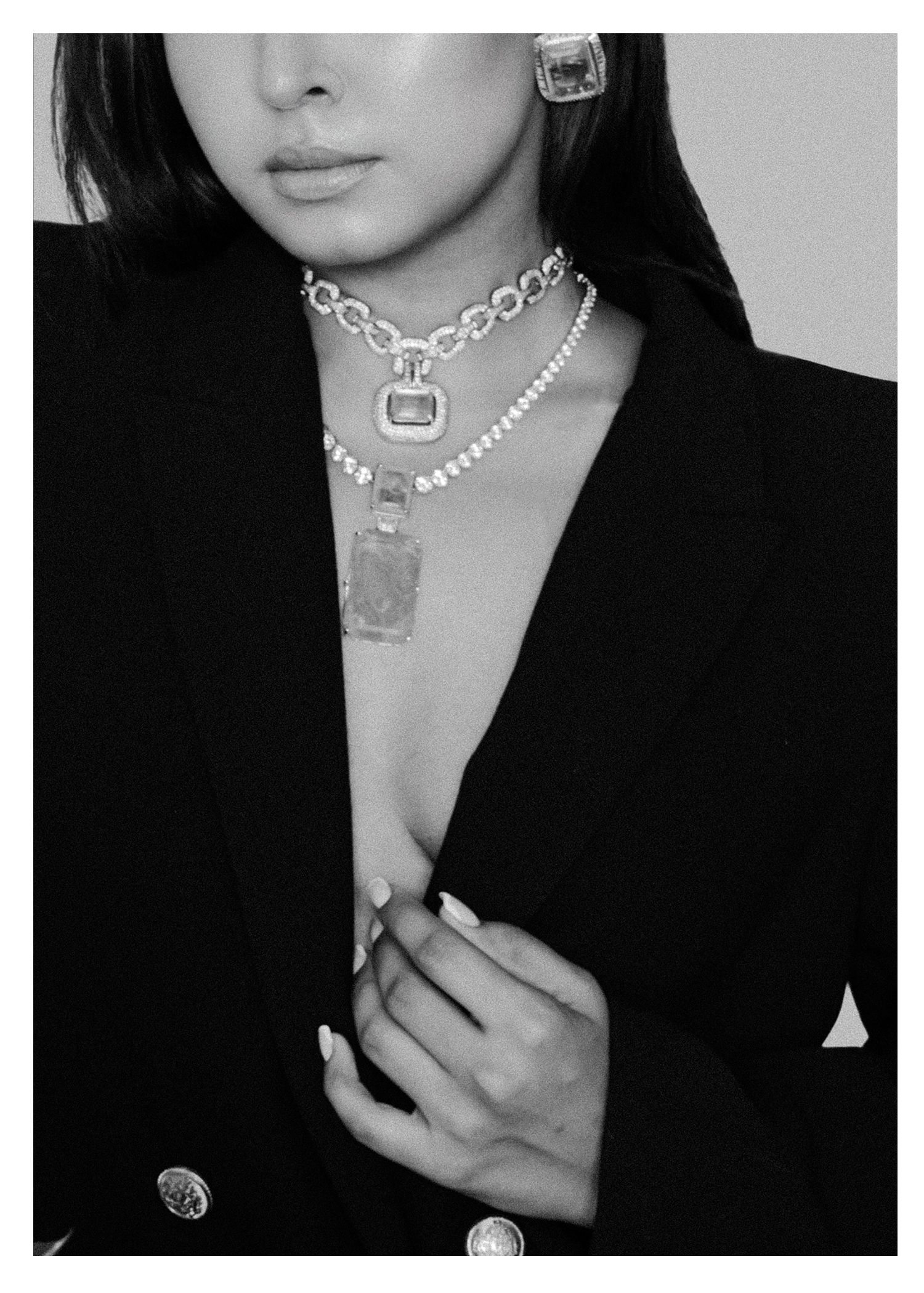 Black and white close-up photos showing silver chain necklaces and pendant jewelry styling against dark clothing.
