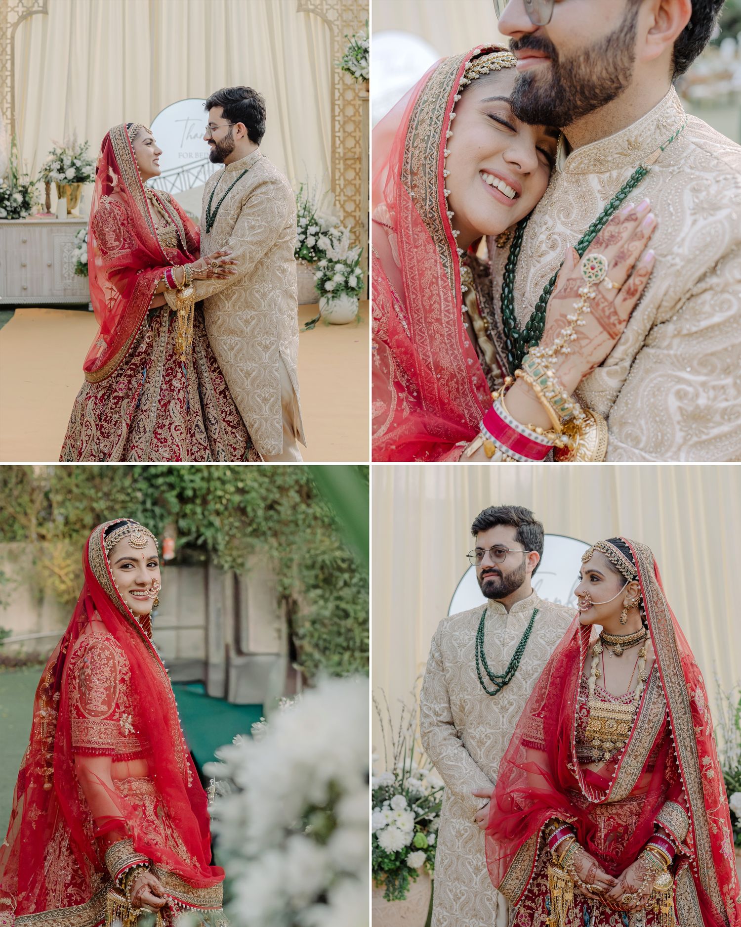 Indian bride in red lehenga and groom in cream sherwani share intimate wedding portraits with floral decor.